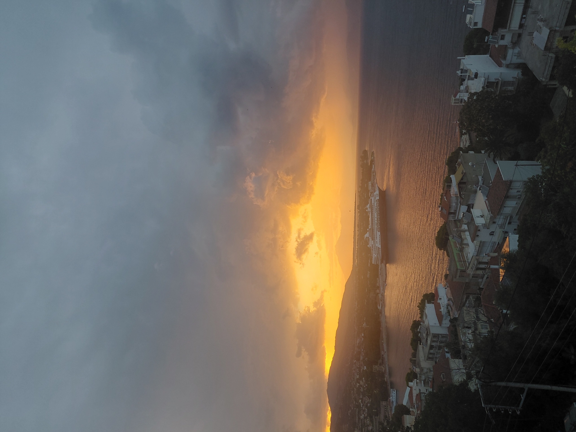 Stormy sunset and cruise ship along the Aegio coastline