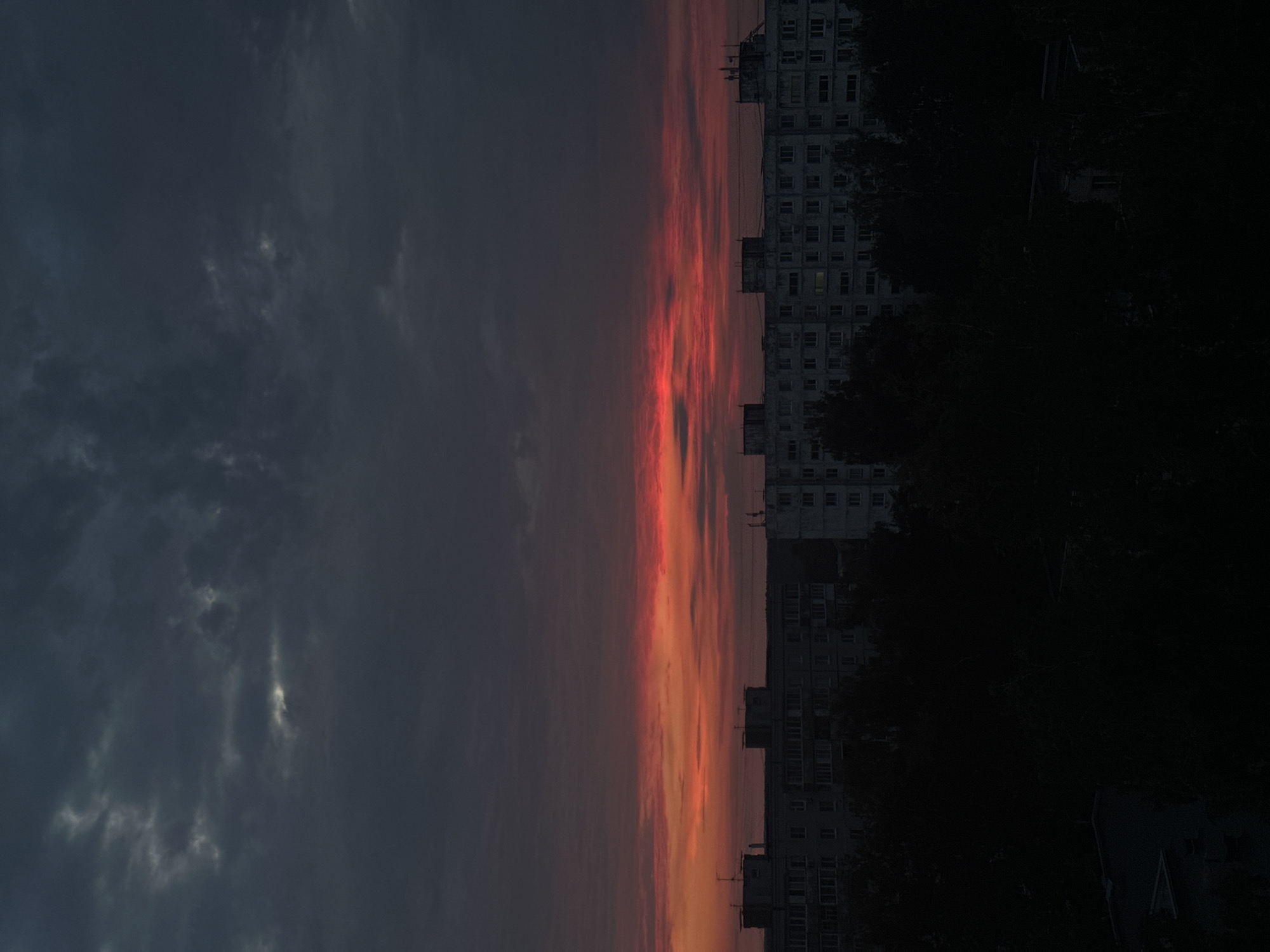 Heavy clouds break over a Kazan city skyline at night.