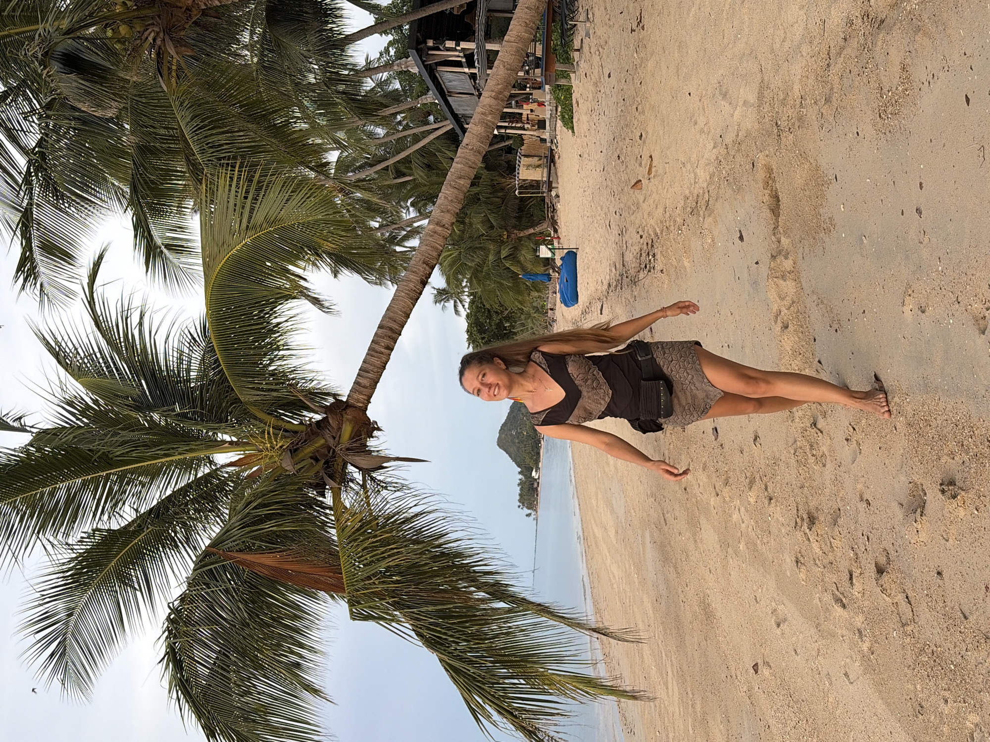 Sunset beach gathering with rainbow flags in Baan Tai, Thailand