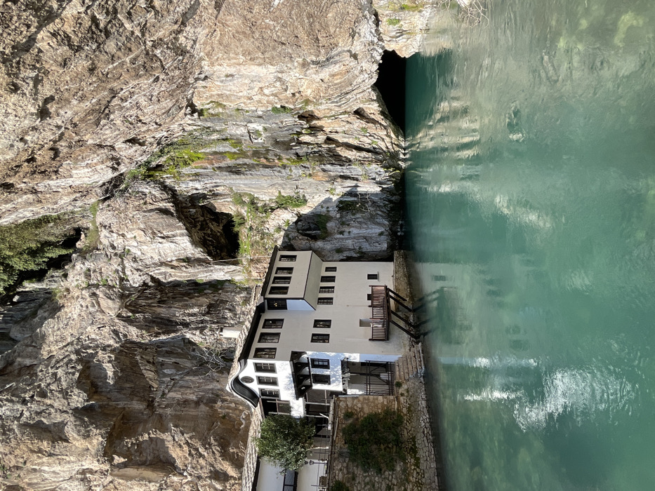 Tourist documents historic Blagaj Tekke monastery at Buna River source