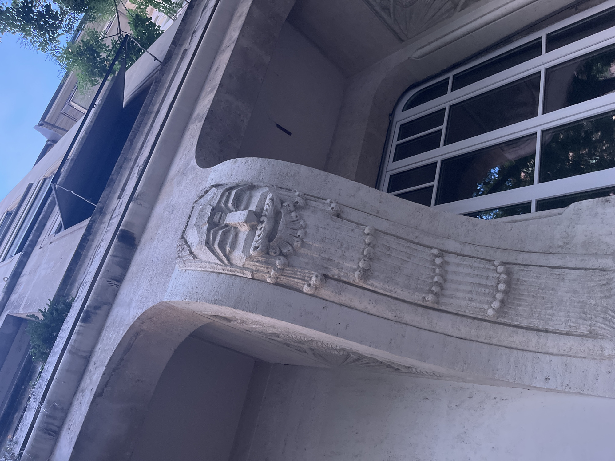 Geneva streetscape: historic facades, tram lines, and a graffiti truck