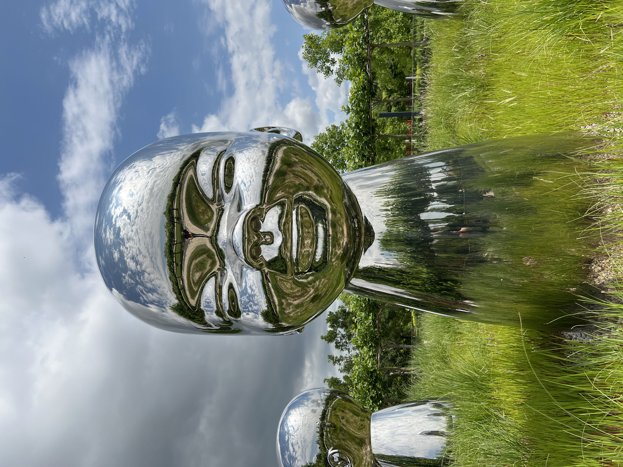 Morning scenes around reflective baby head sculptures in Krasnodar