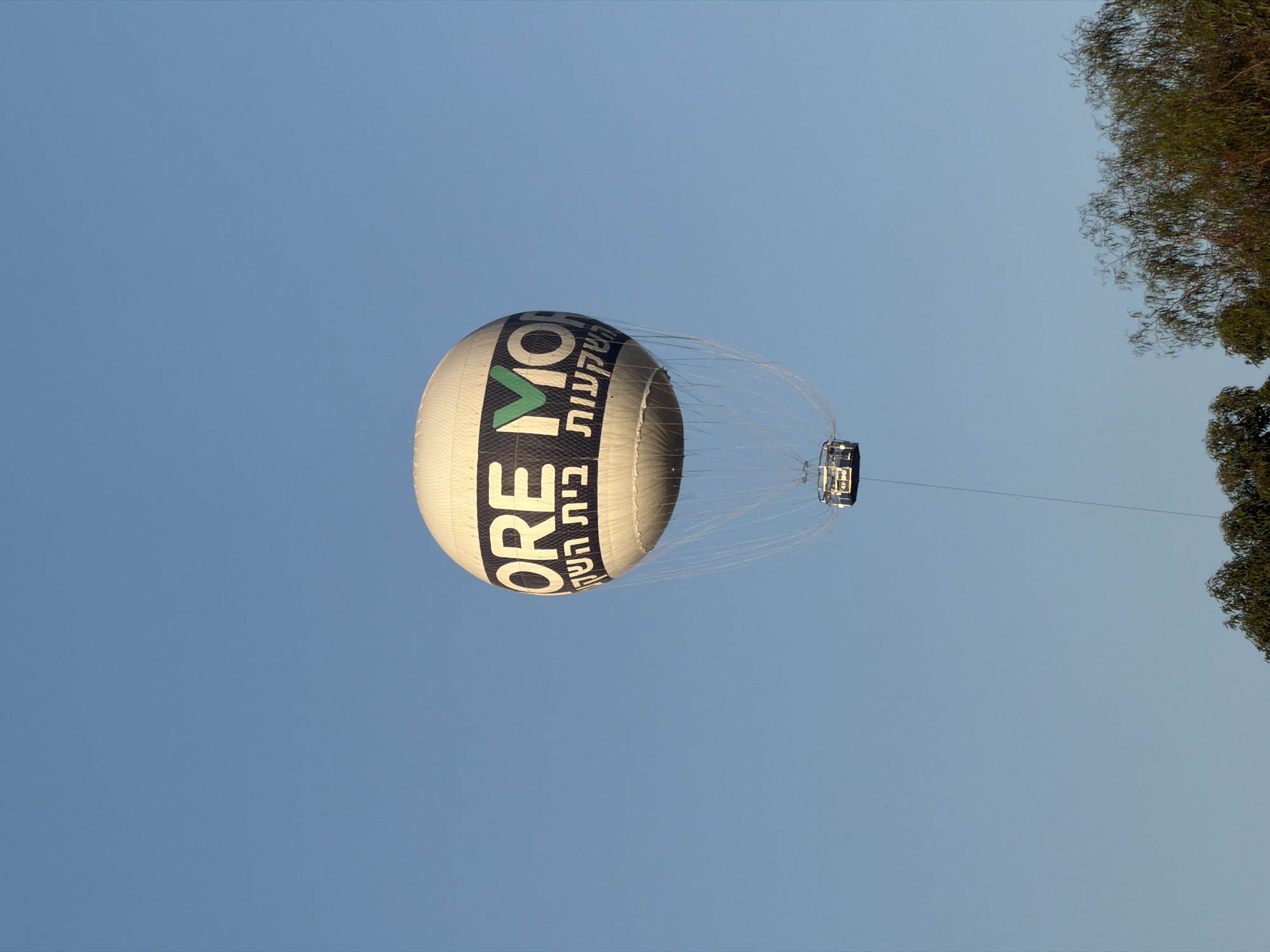 Branded hot air balloon drifts over Tel Aviv skies