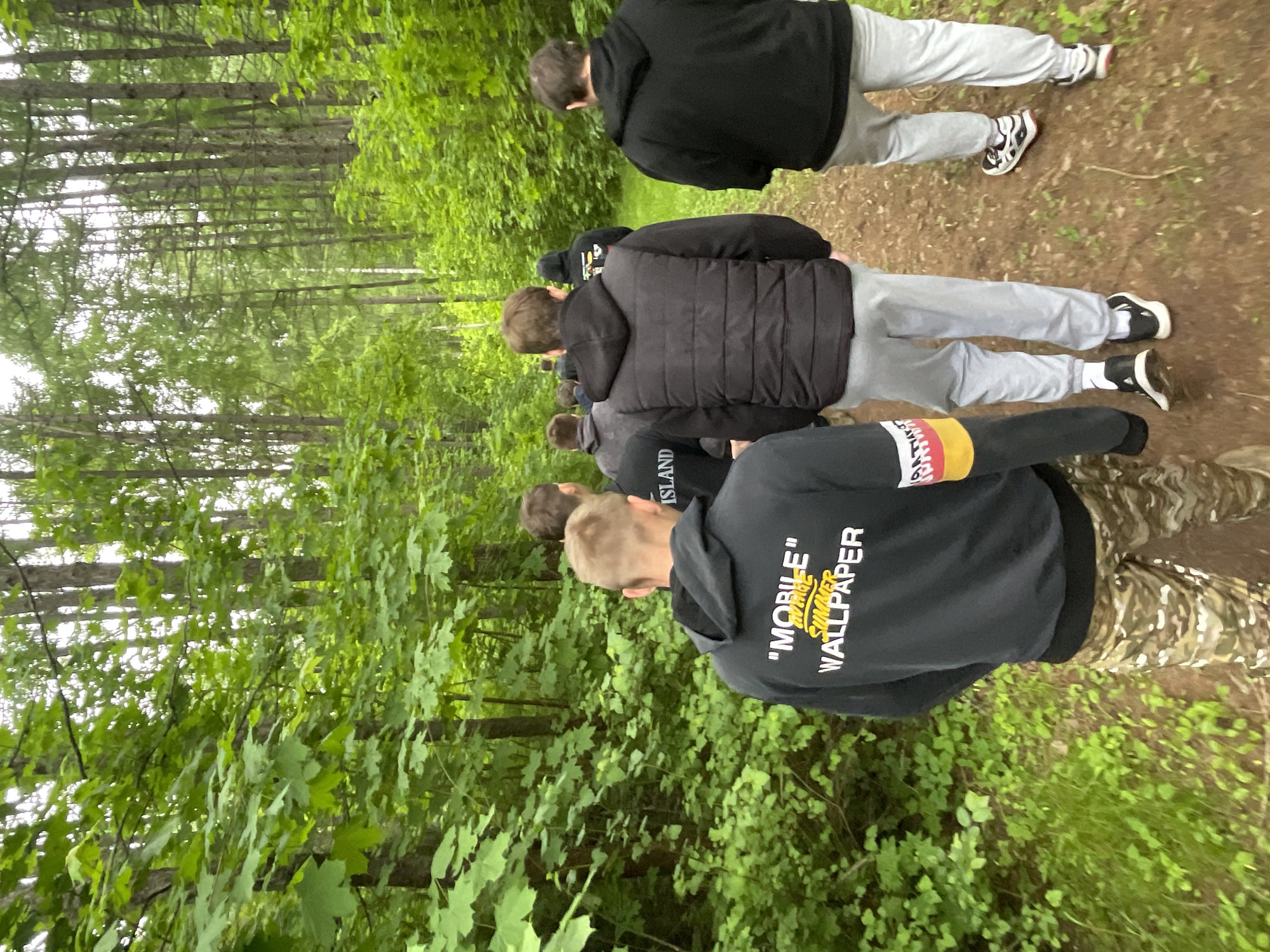 Young men walk forest paths in Krasnye Baki Russia