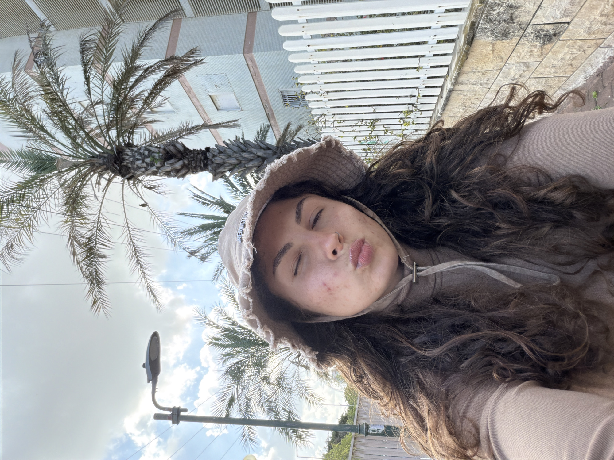 Woman records selfie content on Kiryat Bialik pathway