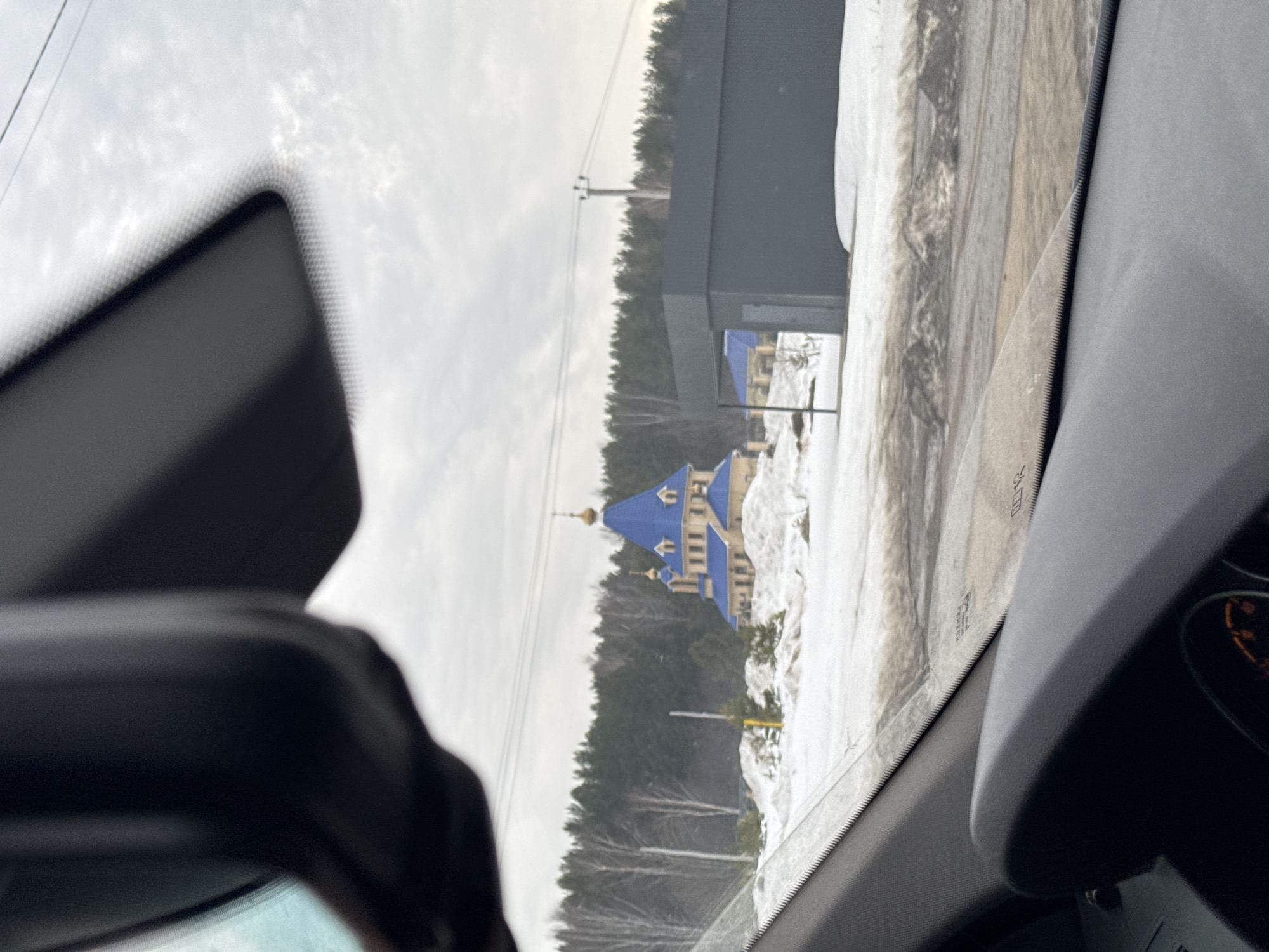 Vehicle view of snow-covered landscape in Chaikovsky, Russia