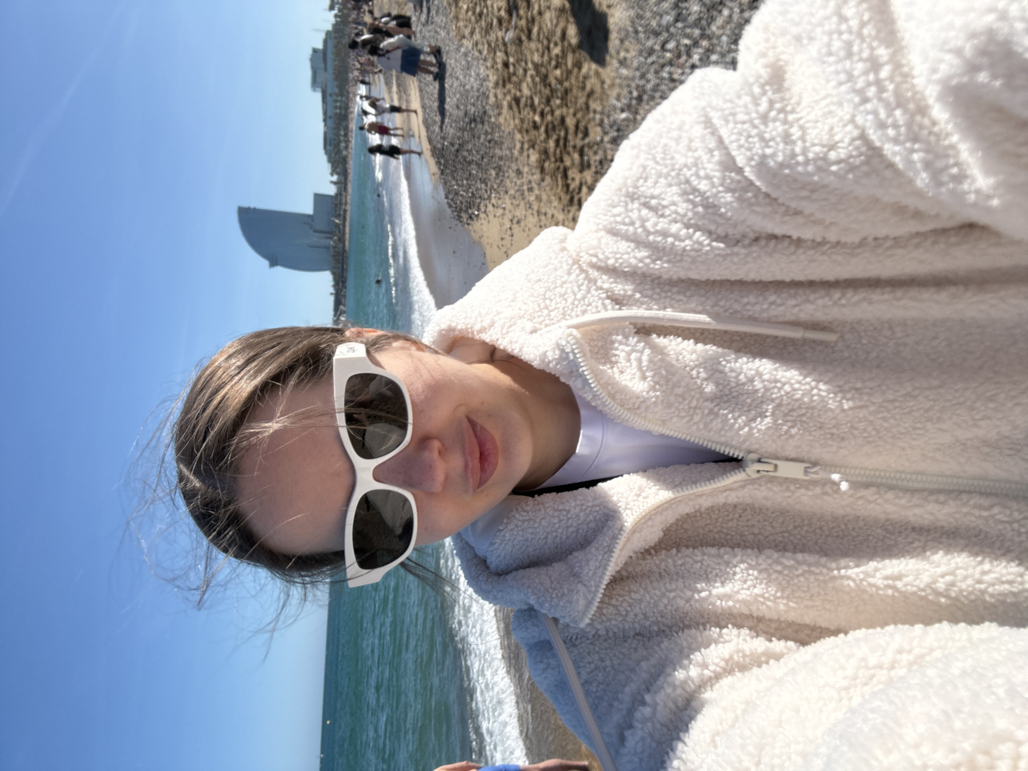 Woman takes selfie at Barcelona's Barceloneta Beach