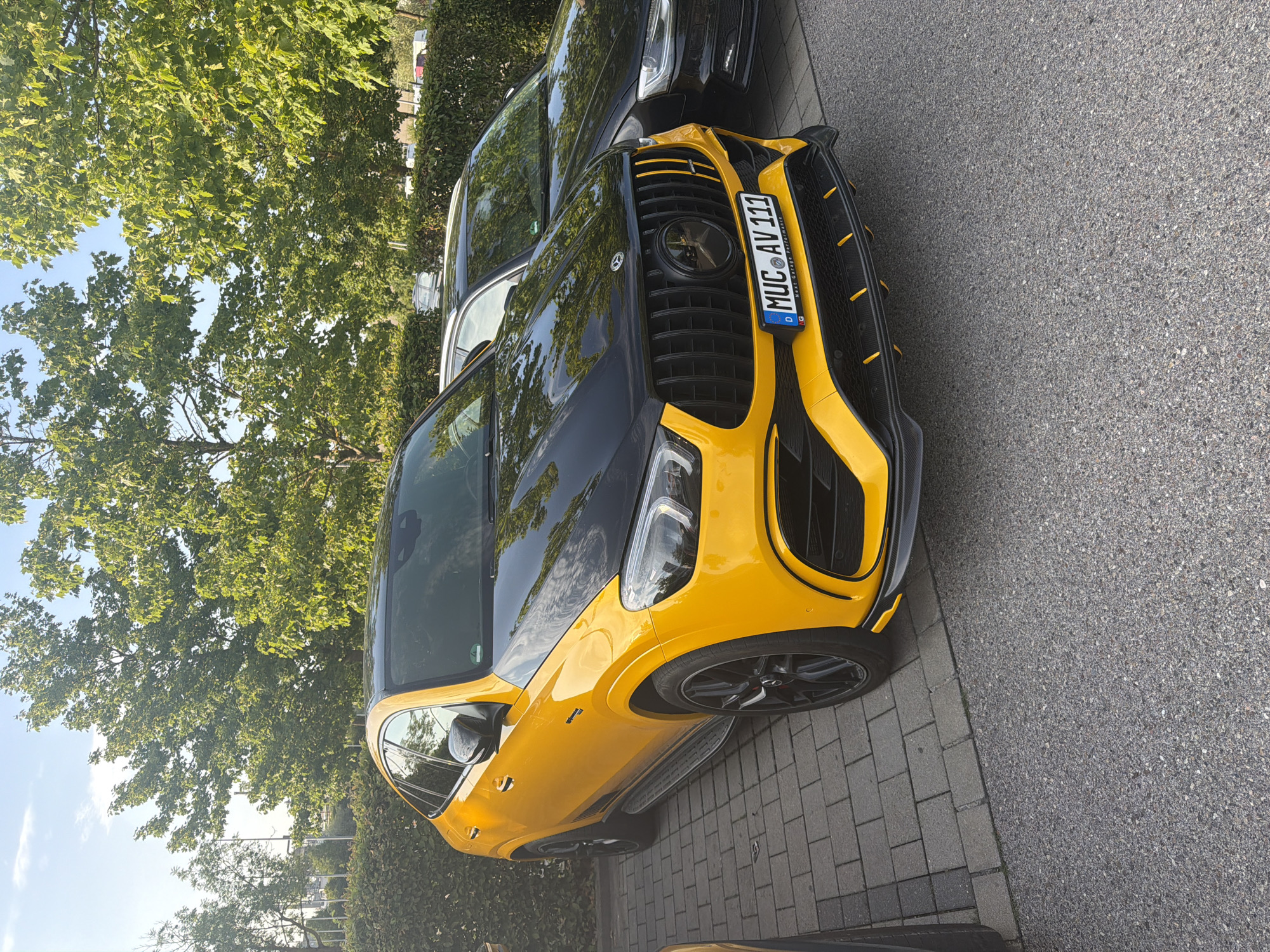 Yellow AMG and silver McLaren parked in Ingolstadt