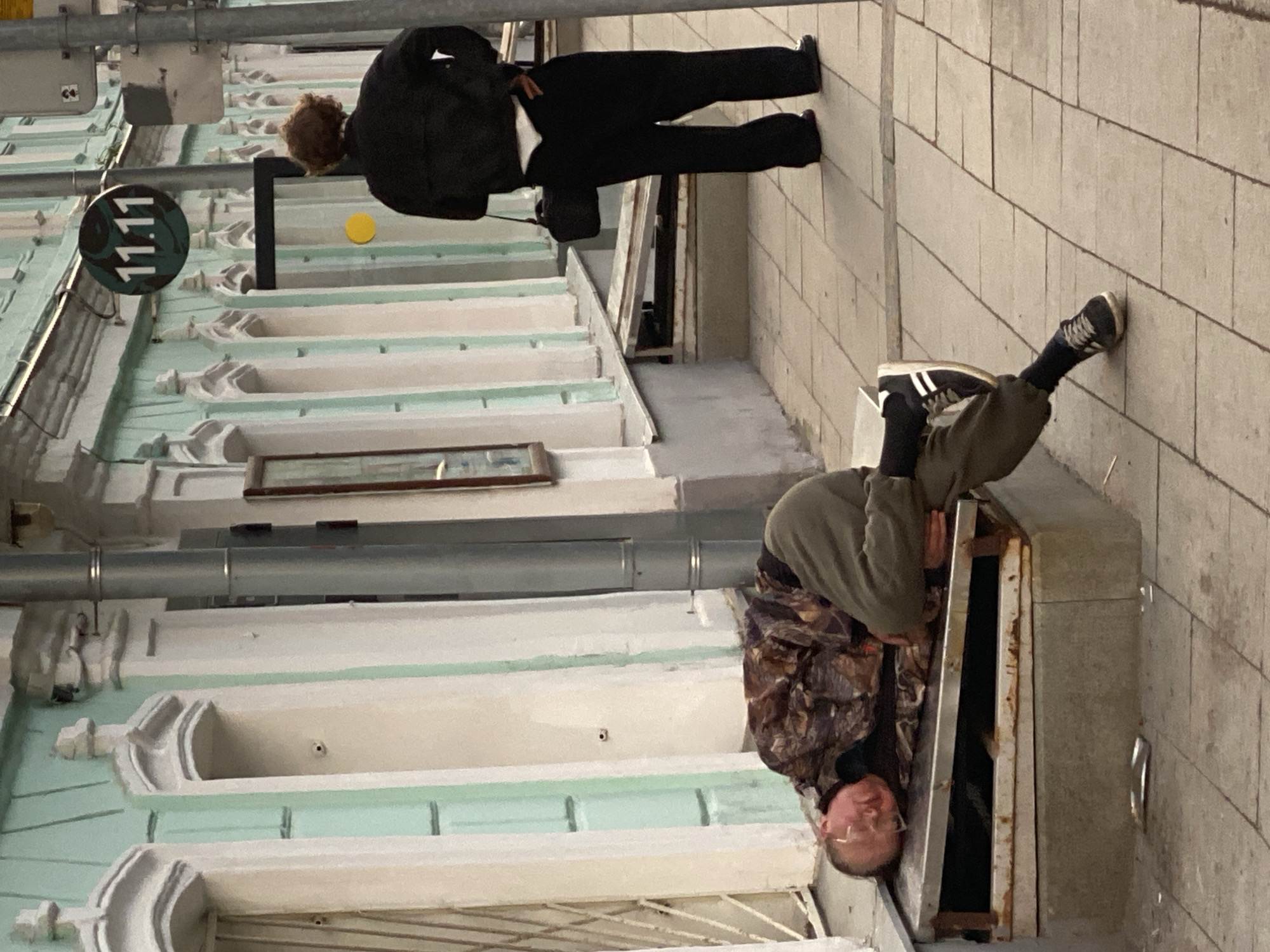 Man enters utility access point on Moscow sidewalk