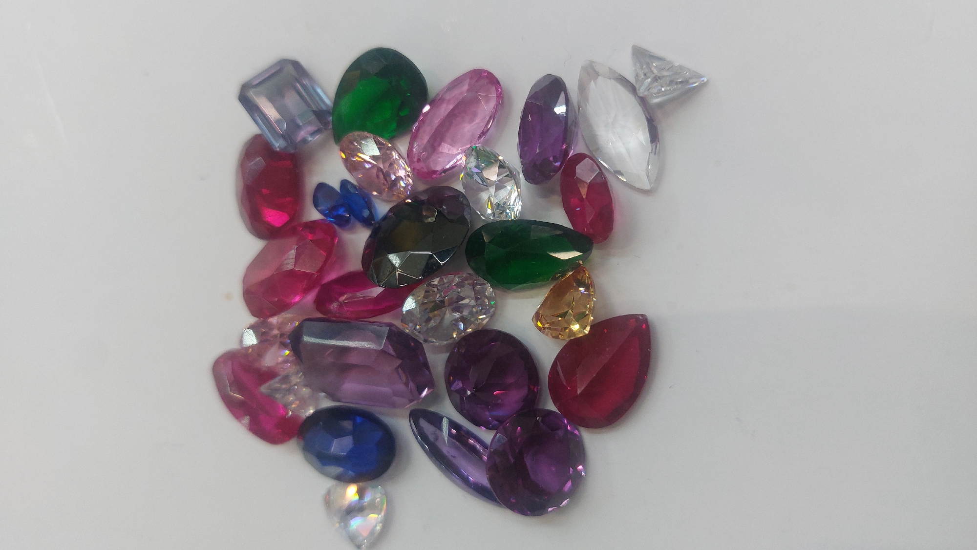Colorful gemstones scattered on white surface in Novosibirsk