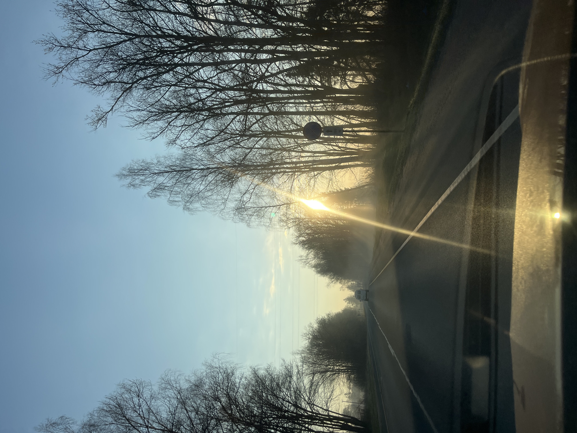 Vehicle travels road during sunrise in Opalevo, Russia