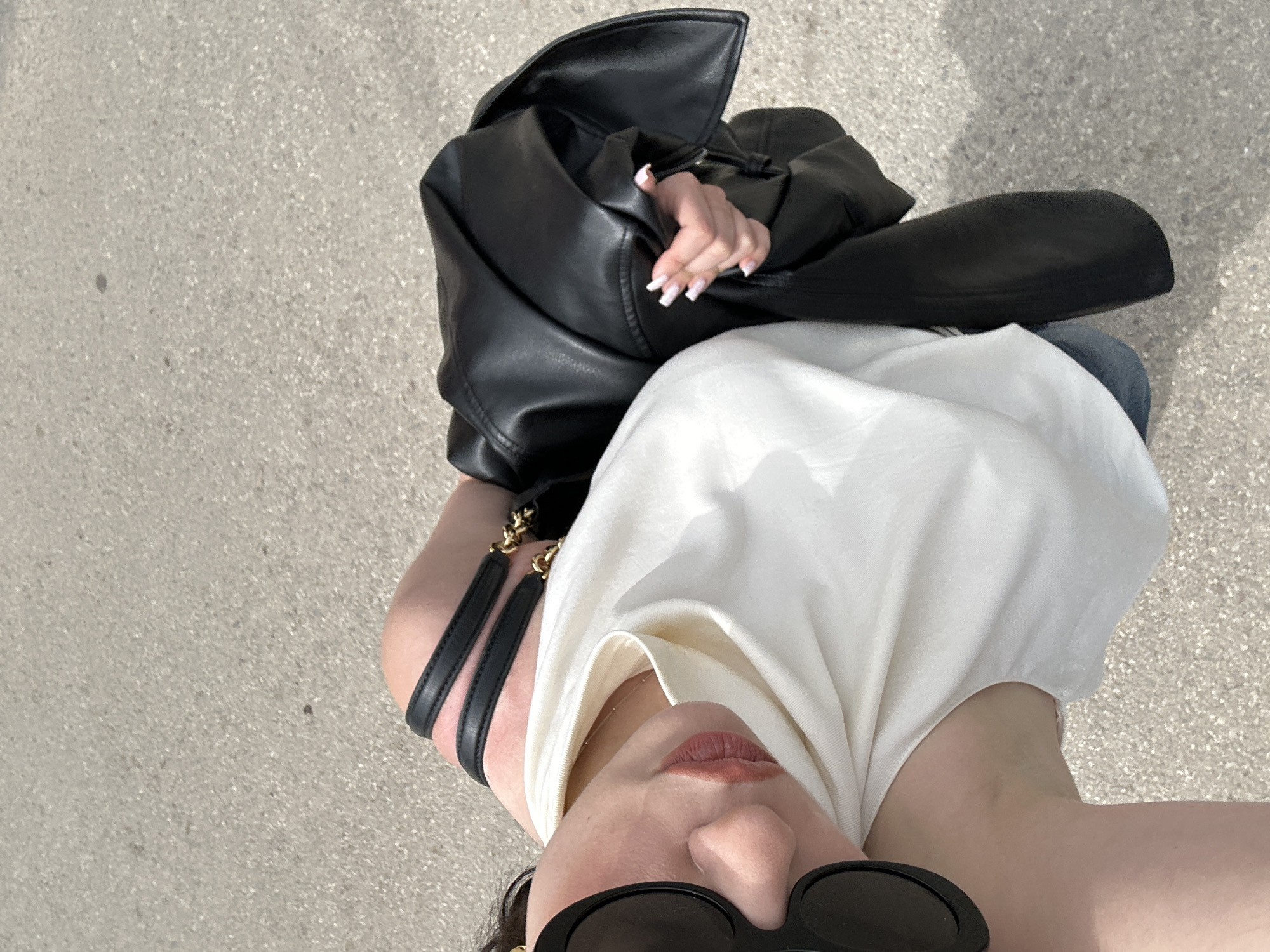 Person photographed with leather jacket near striped building in Sofia