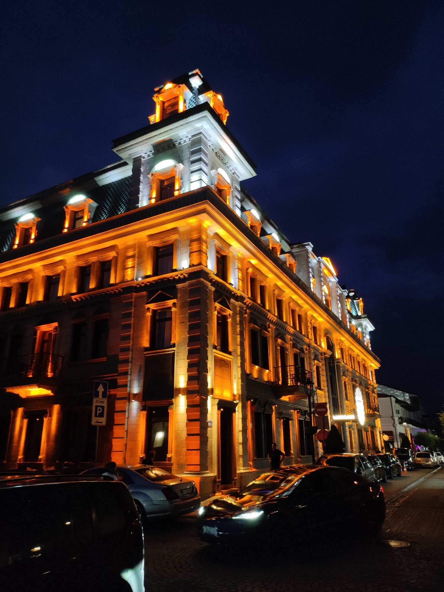 Batumi Fame Casino glowing at night, neoclassical facade lit up