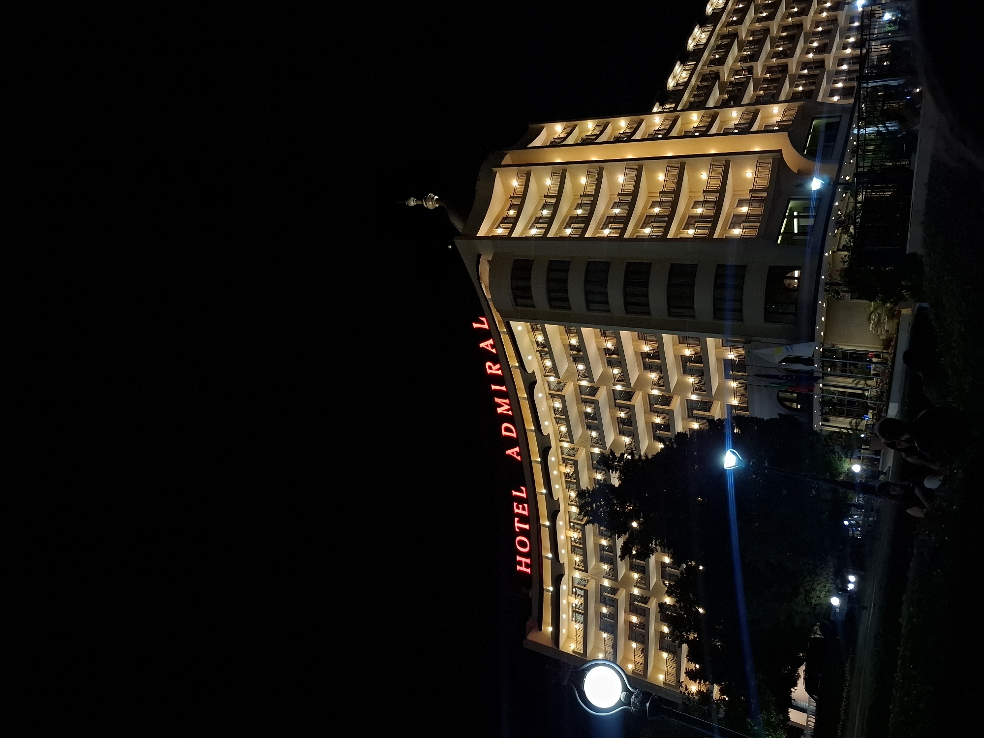 Hotel Admiral glows along Varna's Black Sea waterfront at night.