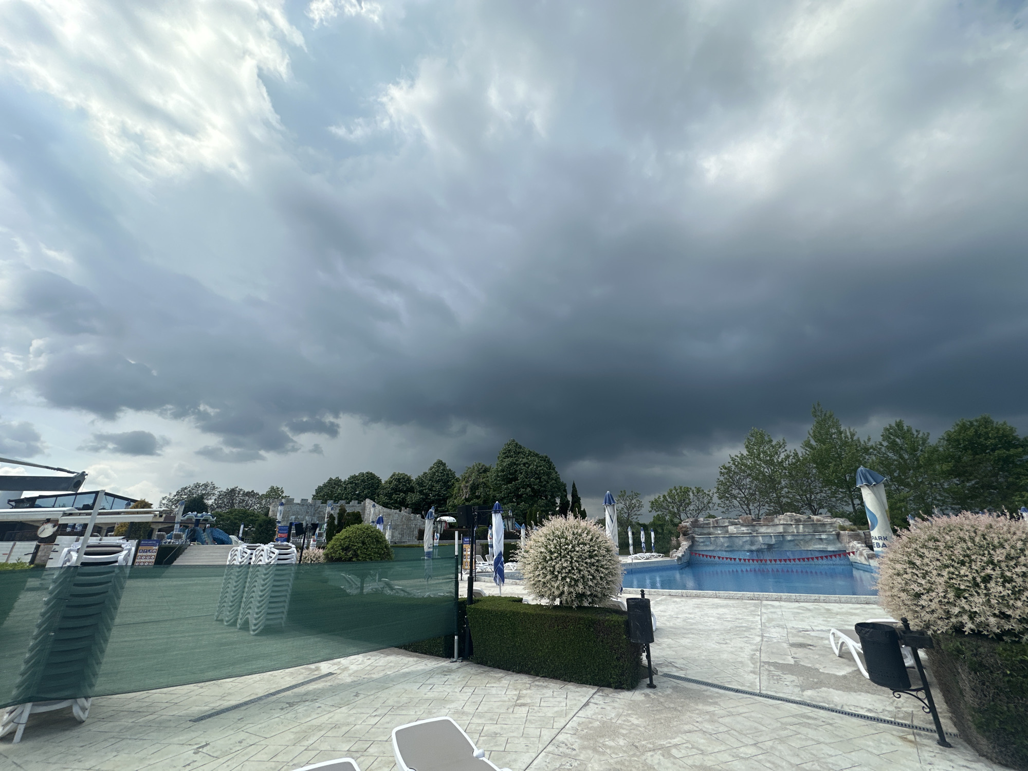 Pool furniture secured under stormy skies in Ravda, Bulgaria