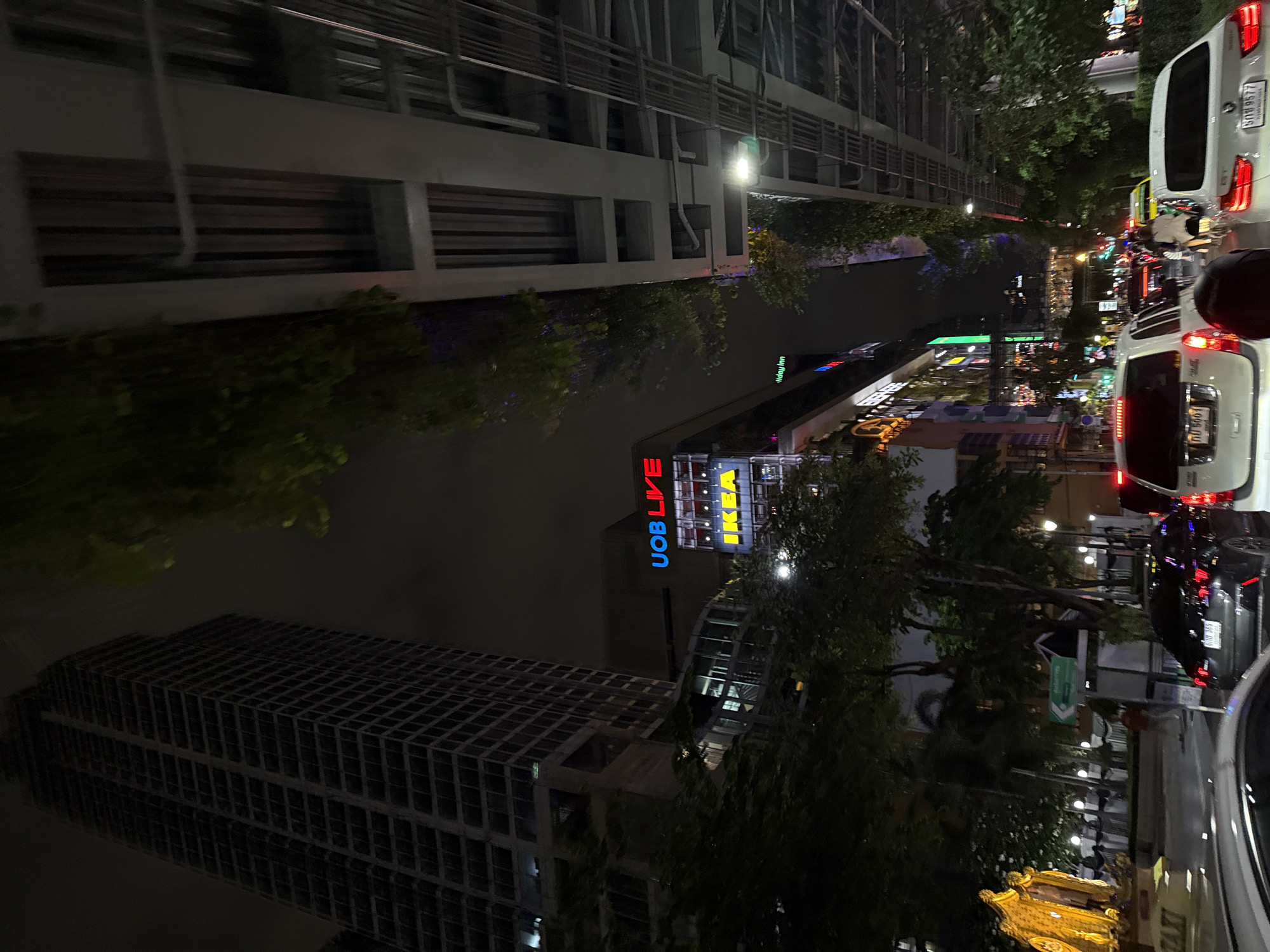 Ground-level nighttime street scene in central Bangkok