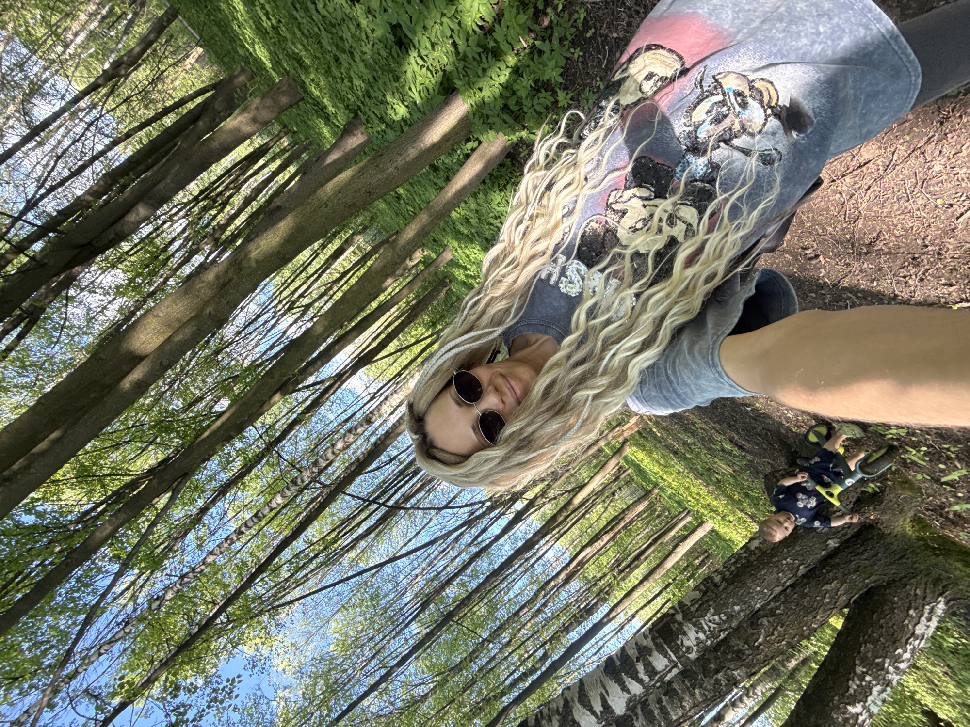 Mother and child enjoy afternoon forest outing near Rusanovo