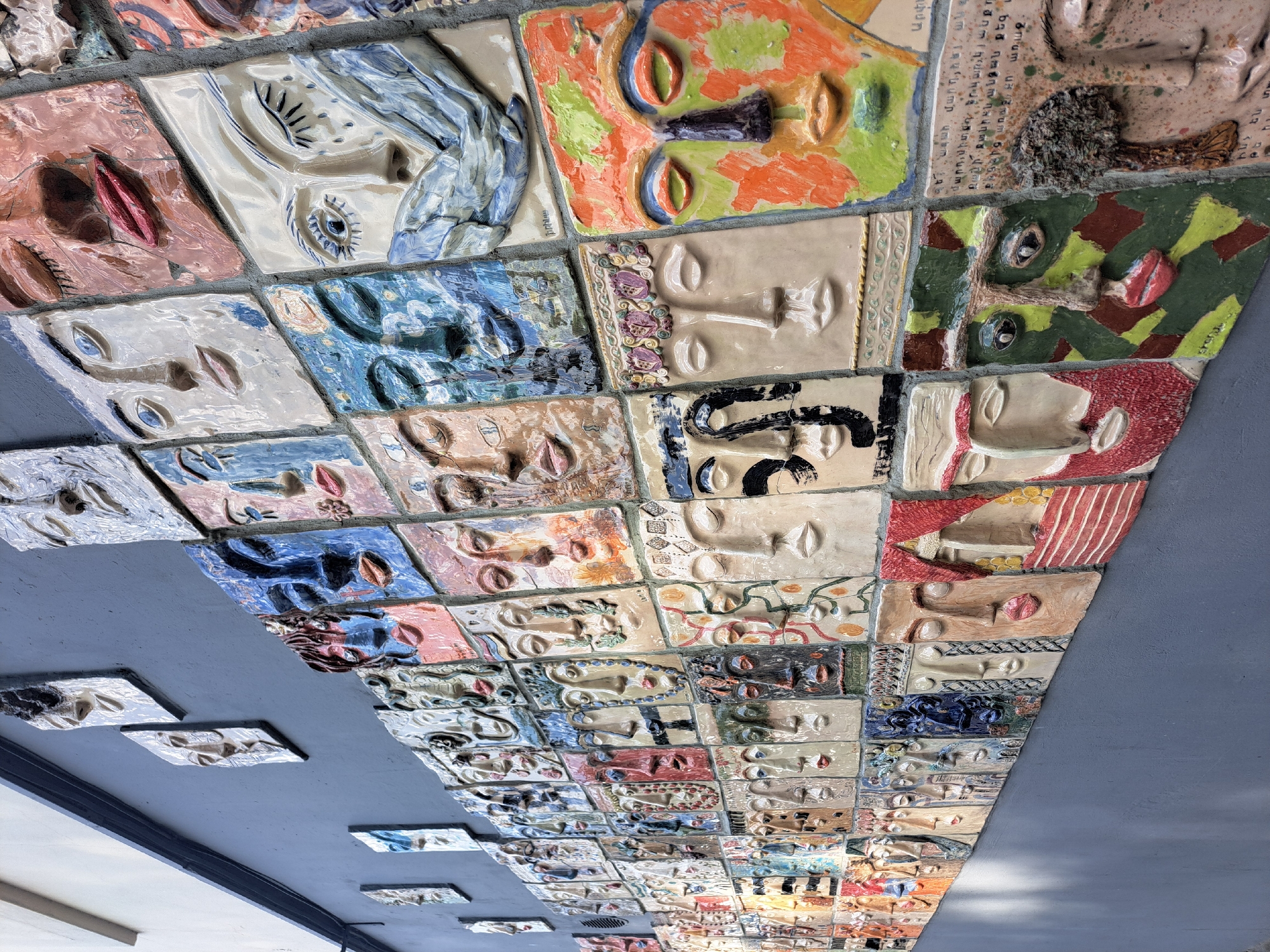 Ceiling art installation with sculpted faces spotted in Yerevan