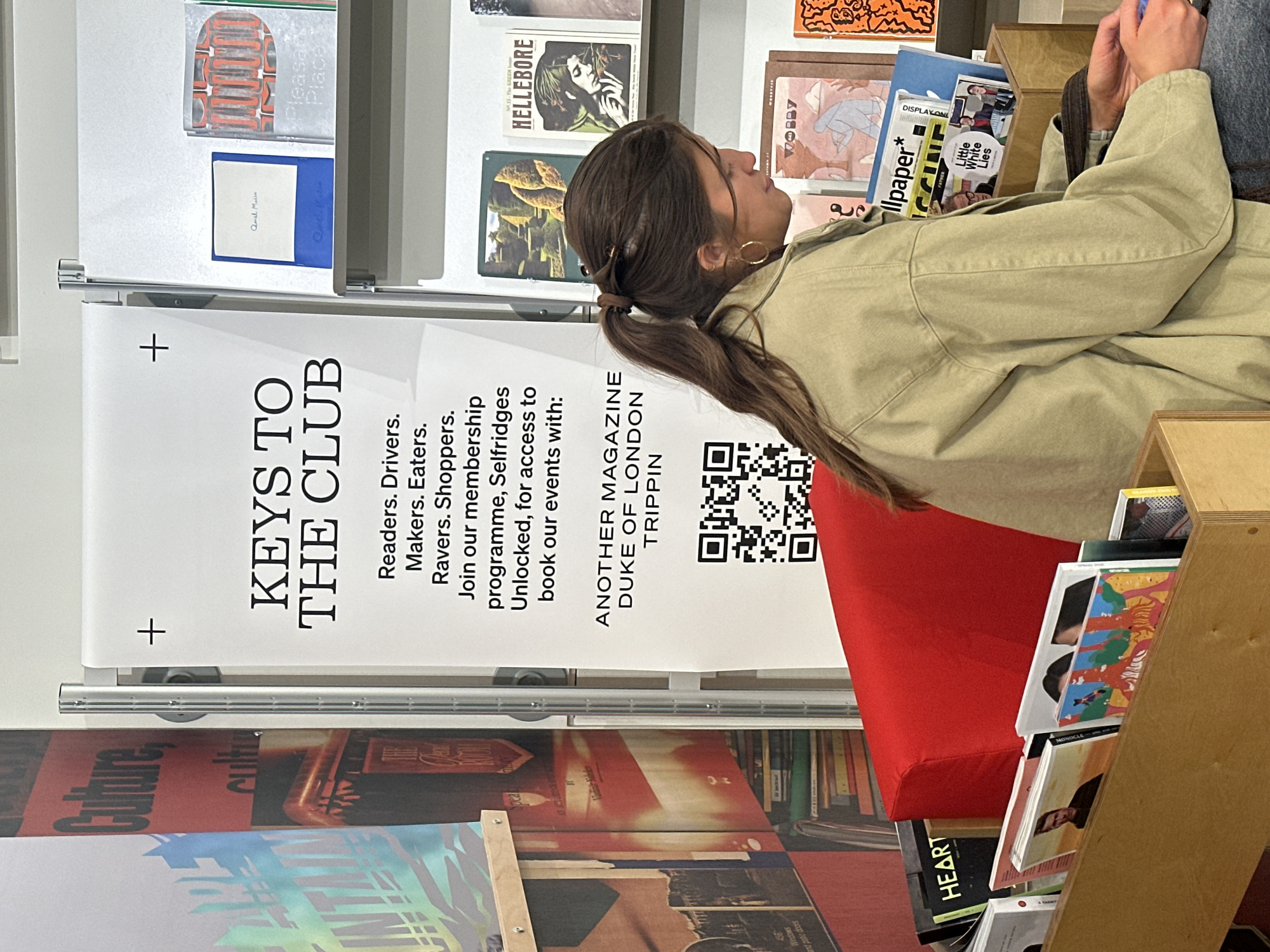 Woman browses magazines at London newsstand