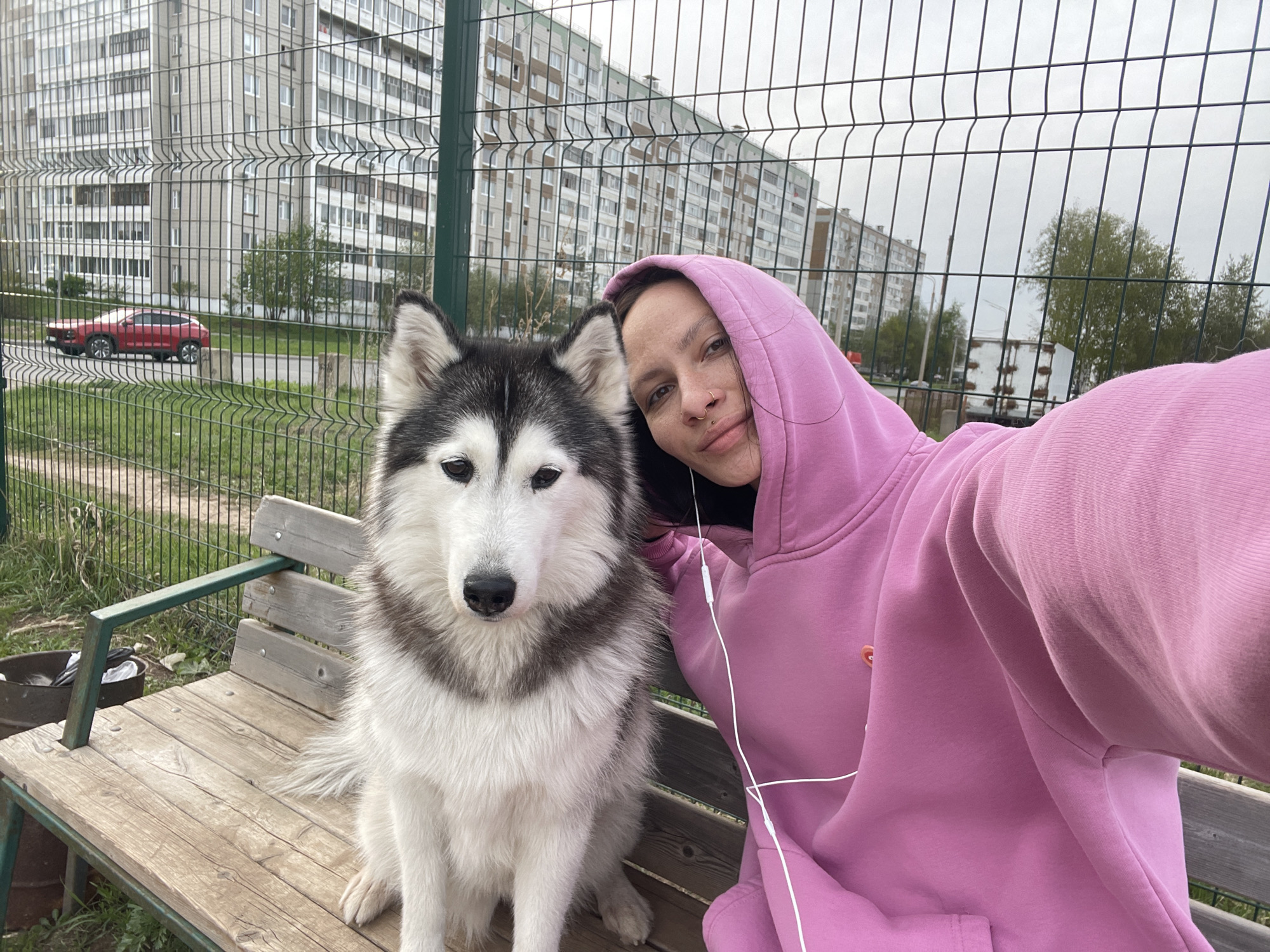 Woman and husky share quiet moment on bench in Izhevsk