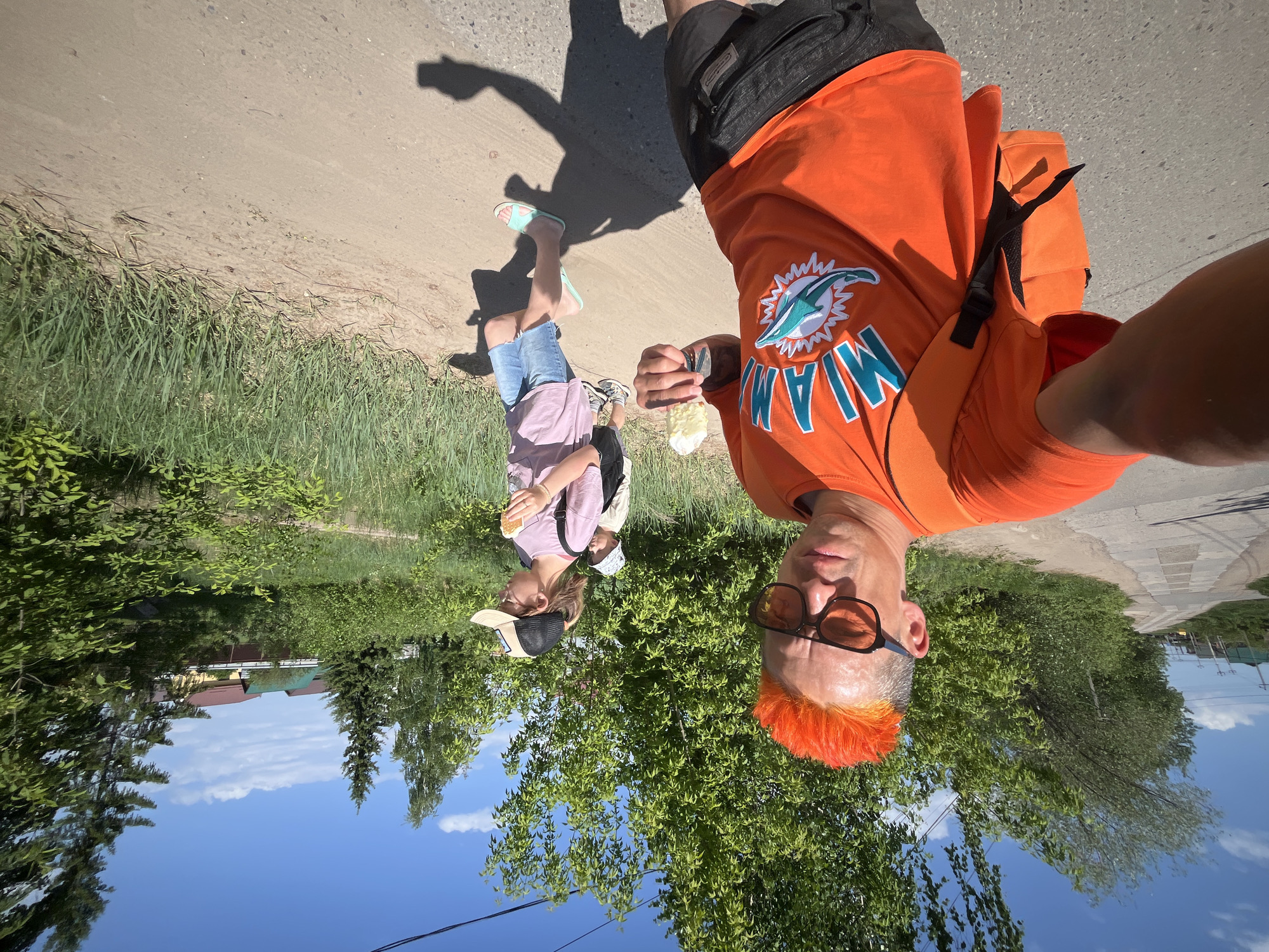 Man in orange enjoys ice cream during morning walk in Chaikovsky