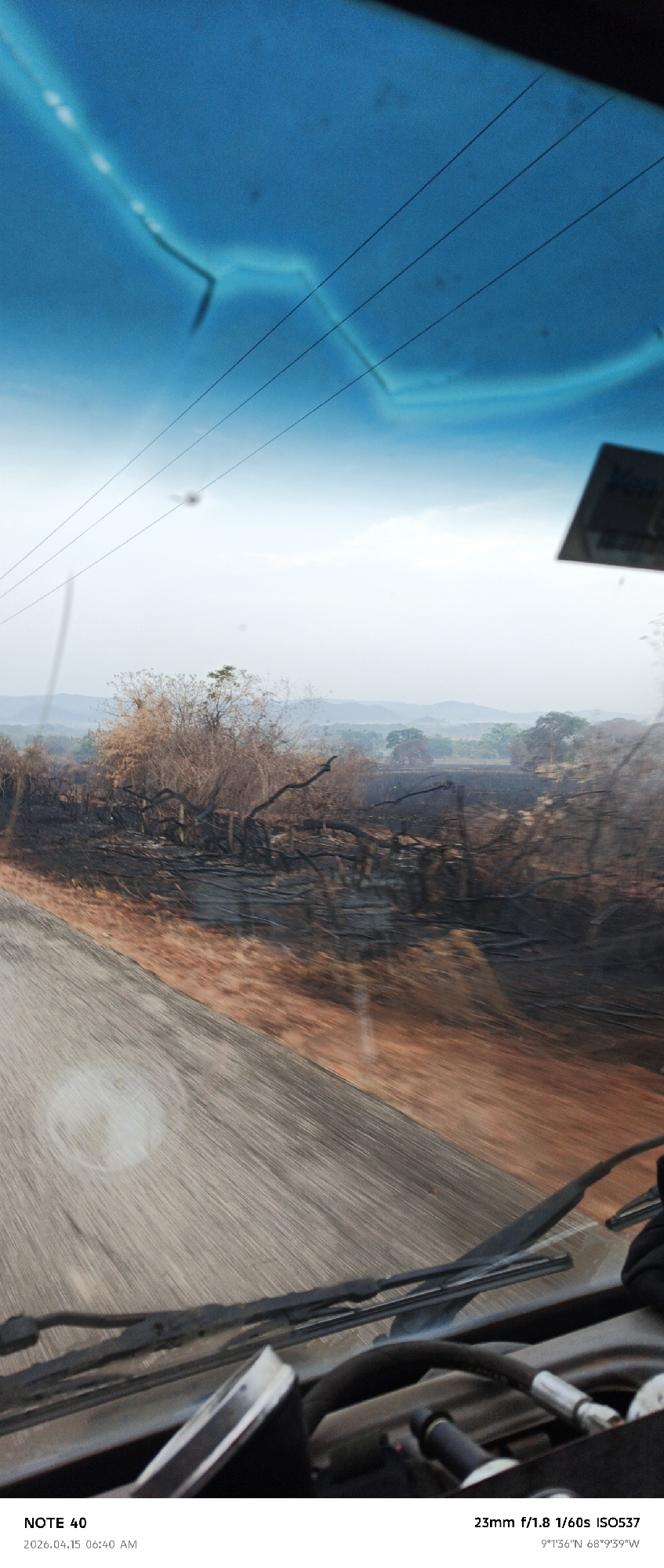 Vehicle drives through fire-damaged landscape in La Cruz, Venezuela
