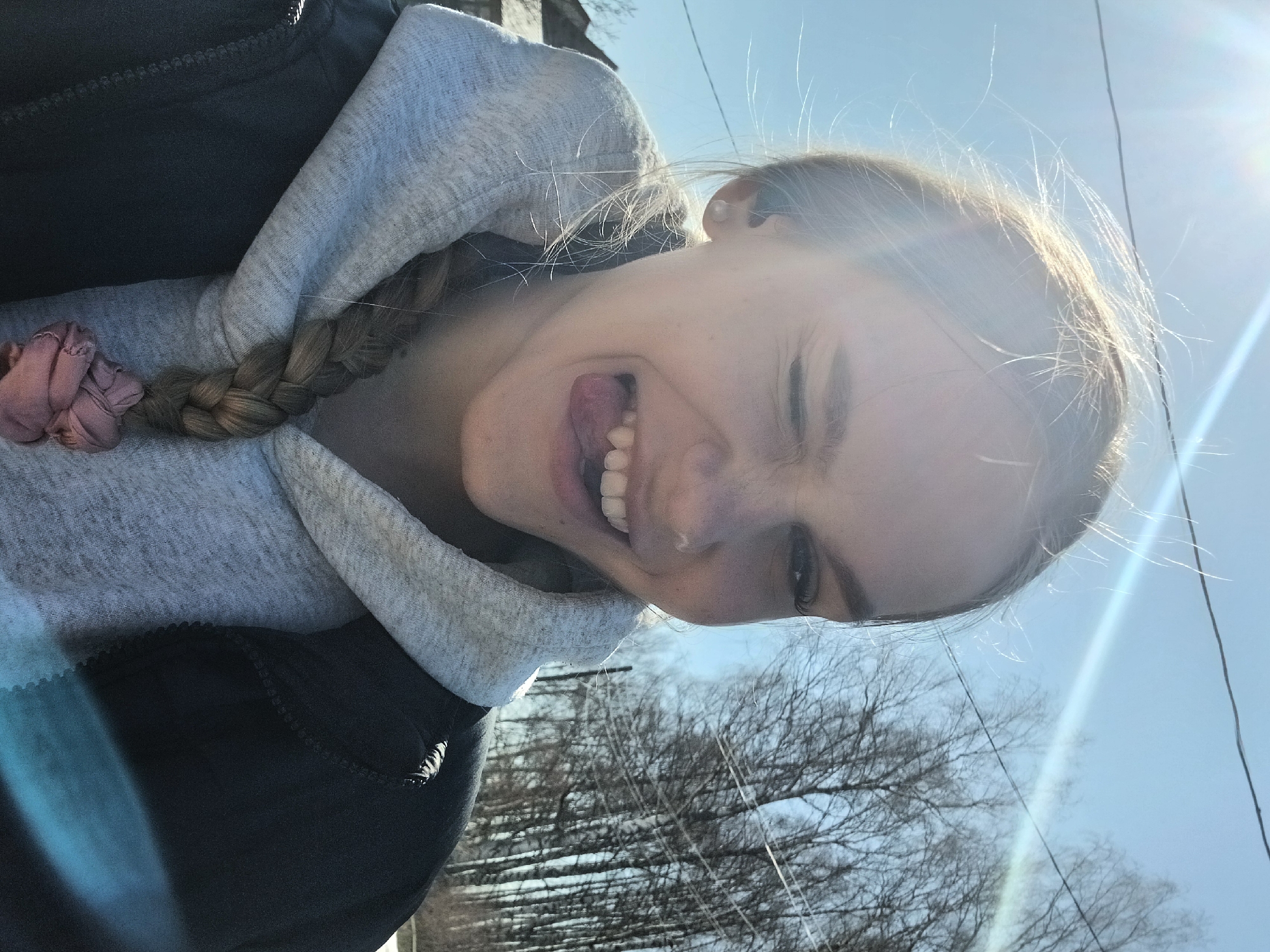 Woman takes spring morning selfies among blooming flowers in Russian forest