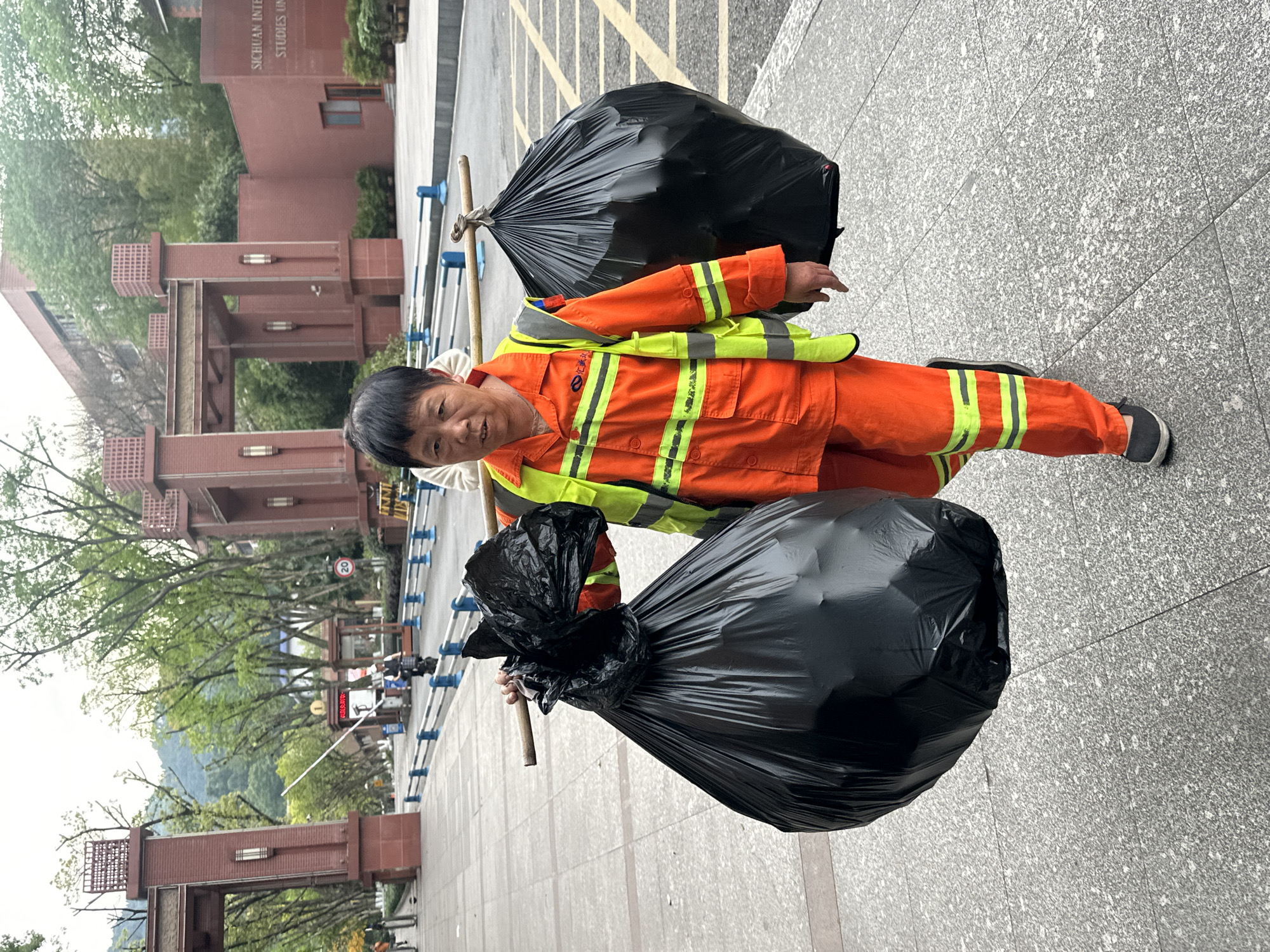 Sanitation worker collects trash in Shapingba District, China
