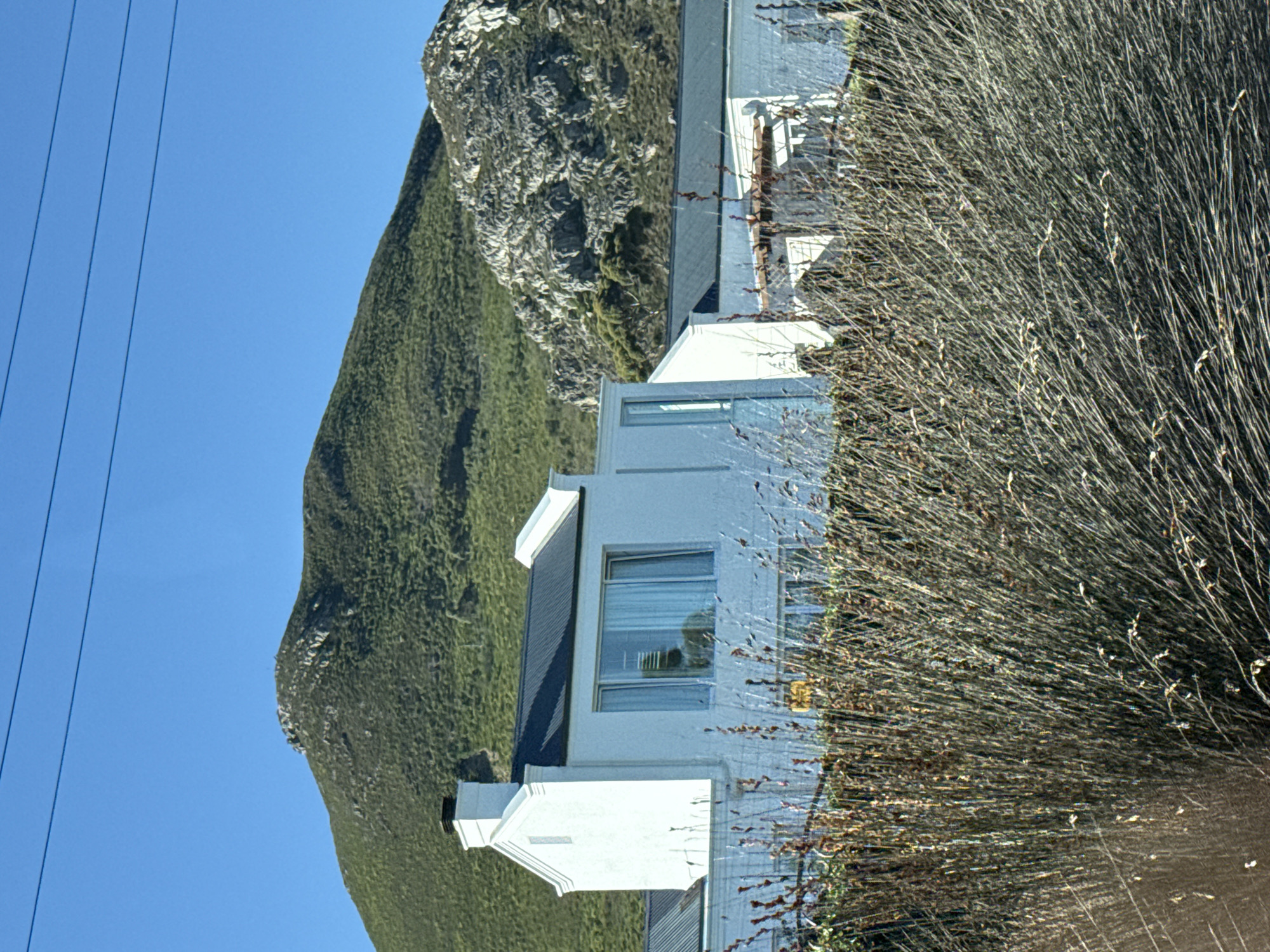 Modern house photographed against verdant mountain in South Africa