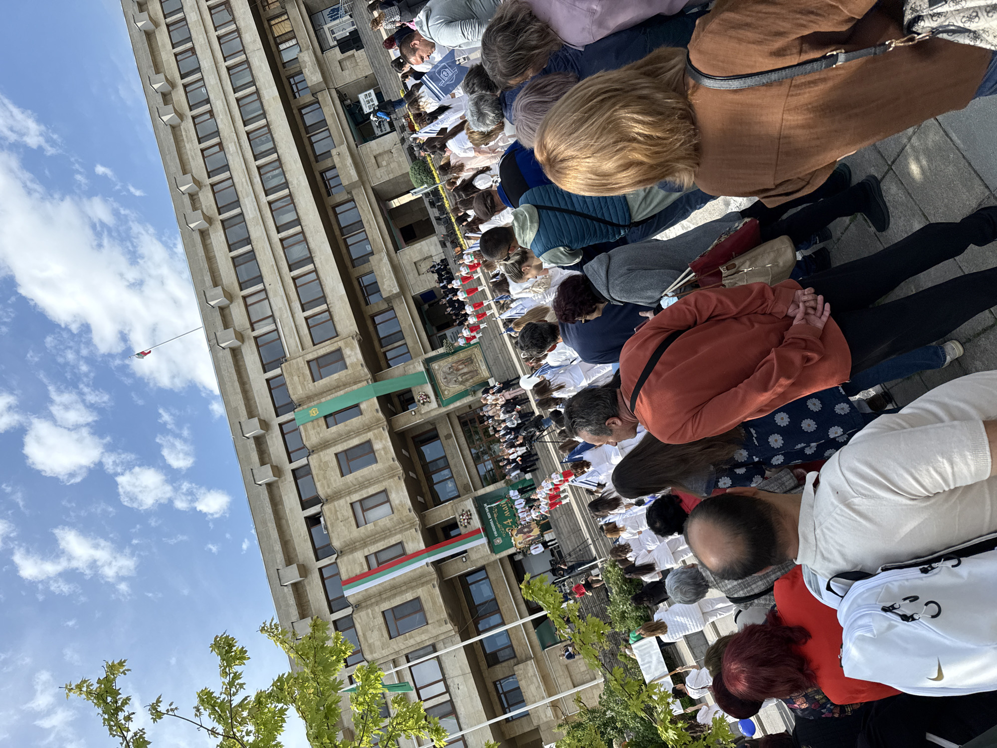 Crowd gathers at flag-decorated government building in Shumen, Bulgaria