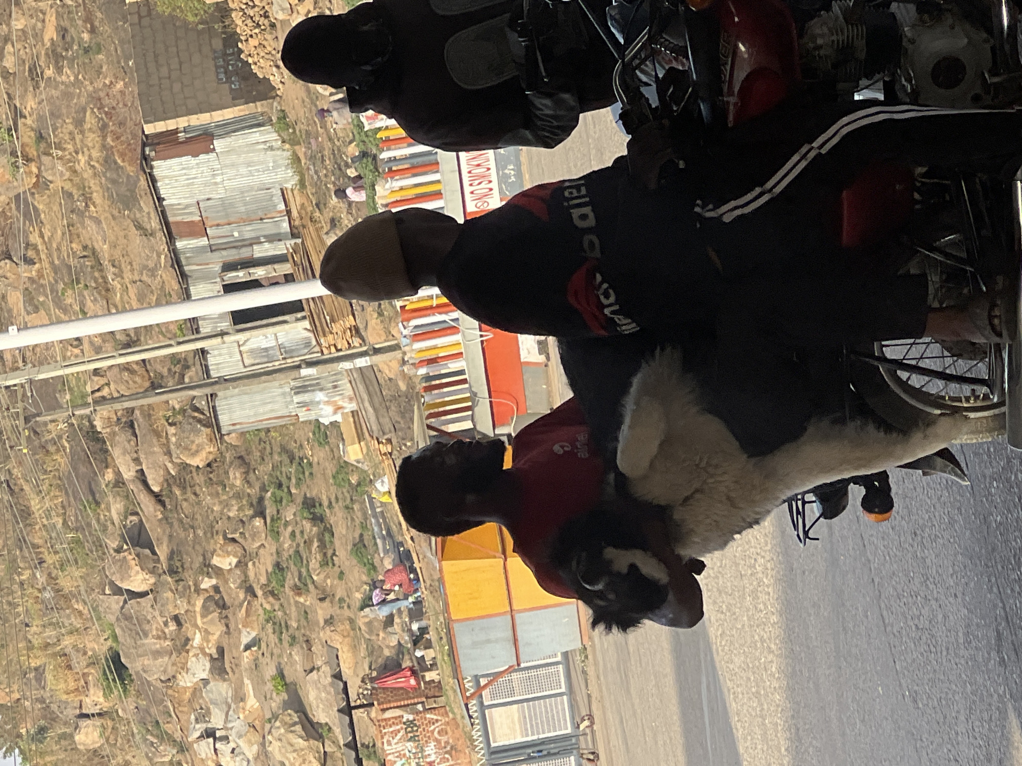 Morning street gathering captured around motorcycle in Jos, Nigeria