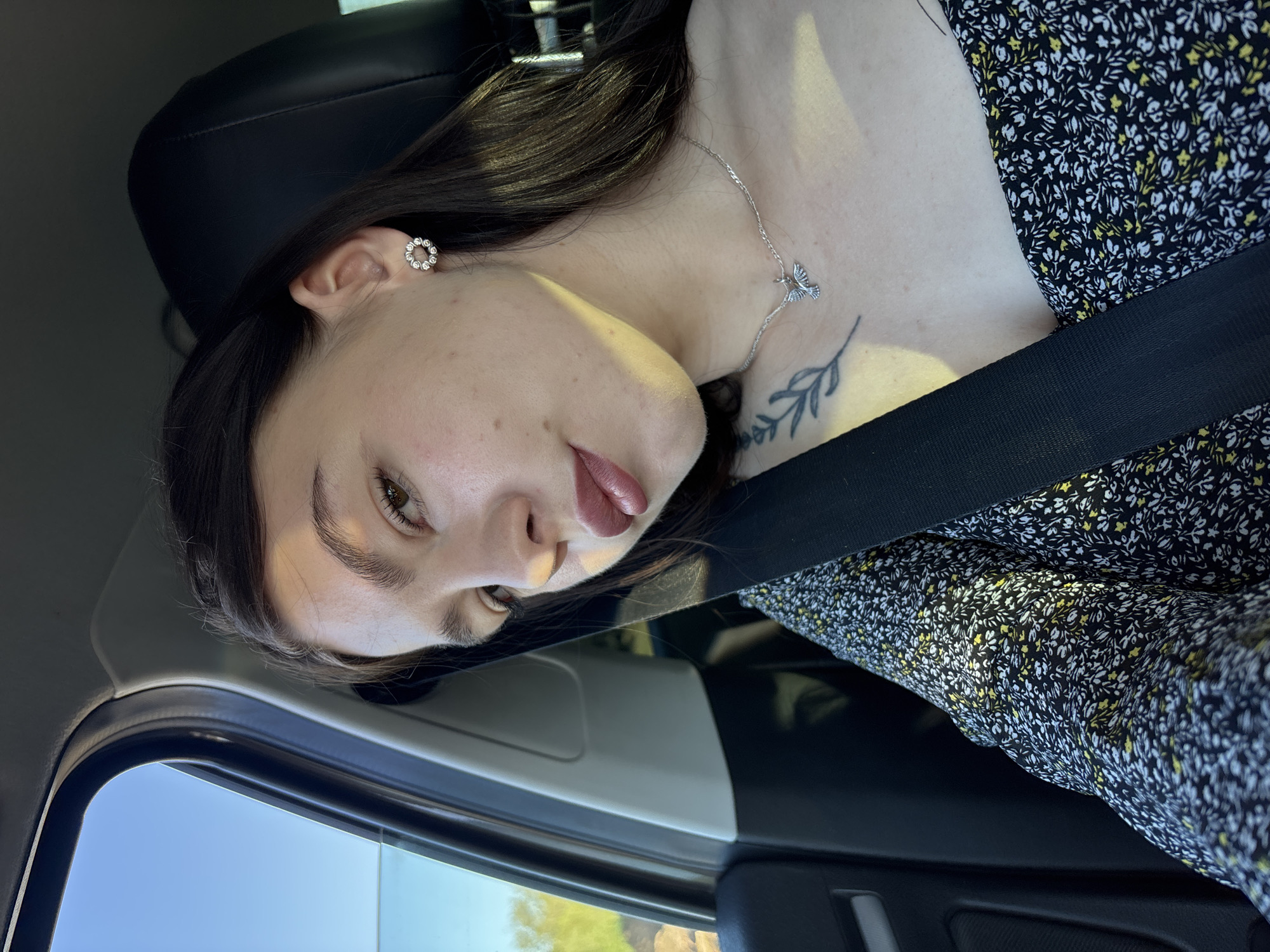 Woman in floral dress observed as car passenger in Perm