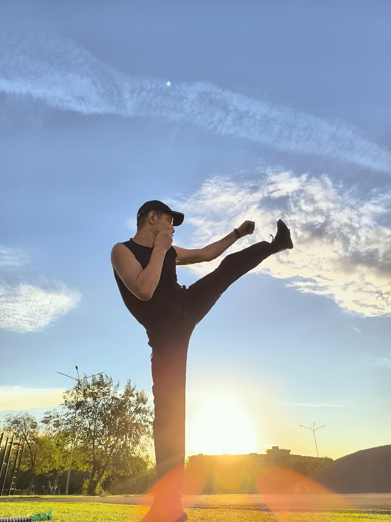 Martial arts training at sunset on a Qarağandı turf field