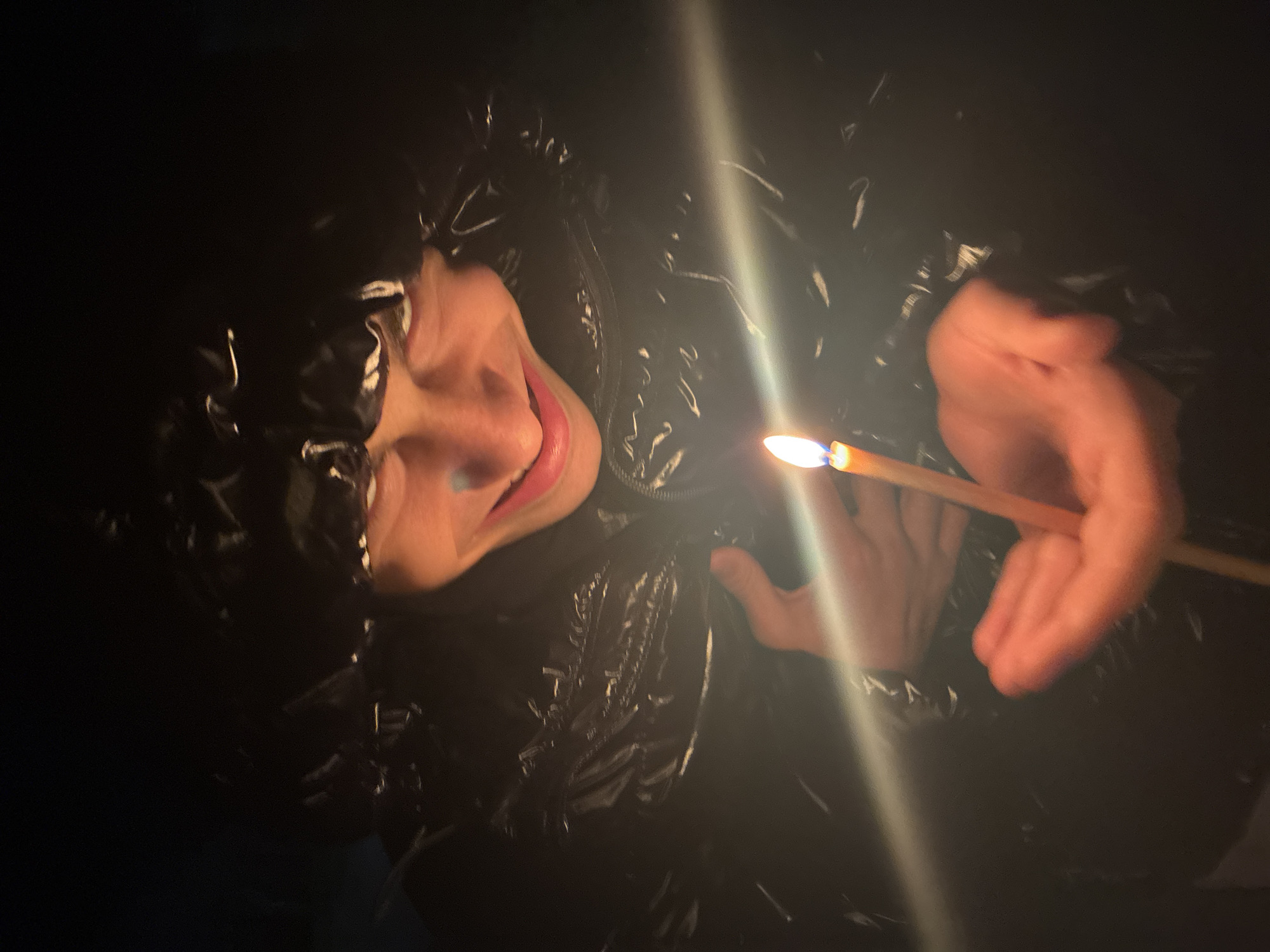 Person uses makeshift lighting in darkness in Bulgarian village