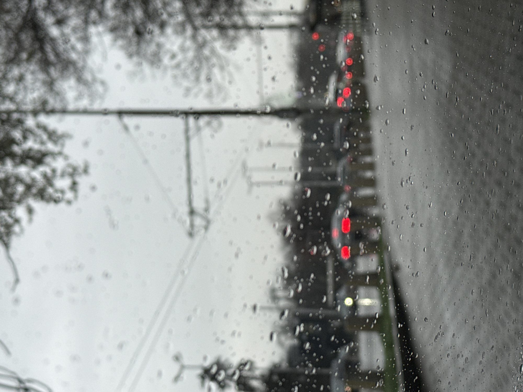 Rainy day traffic scene captured through window in Sofia
