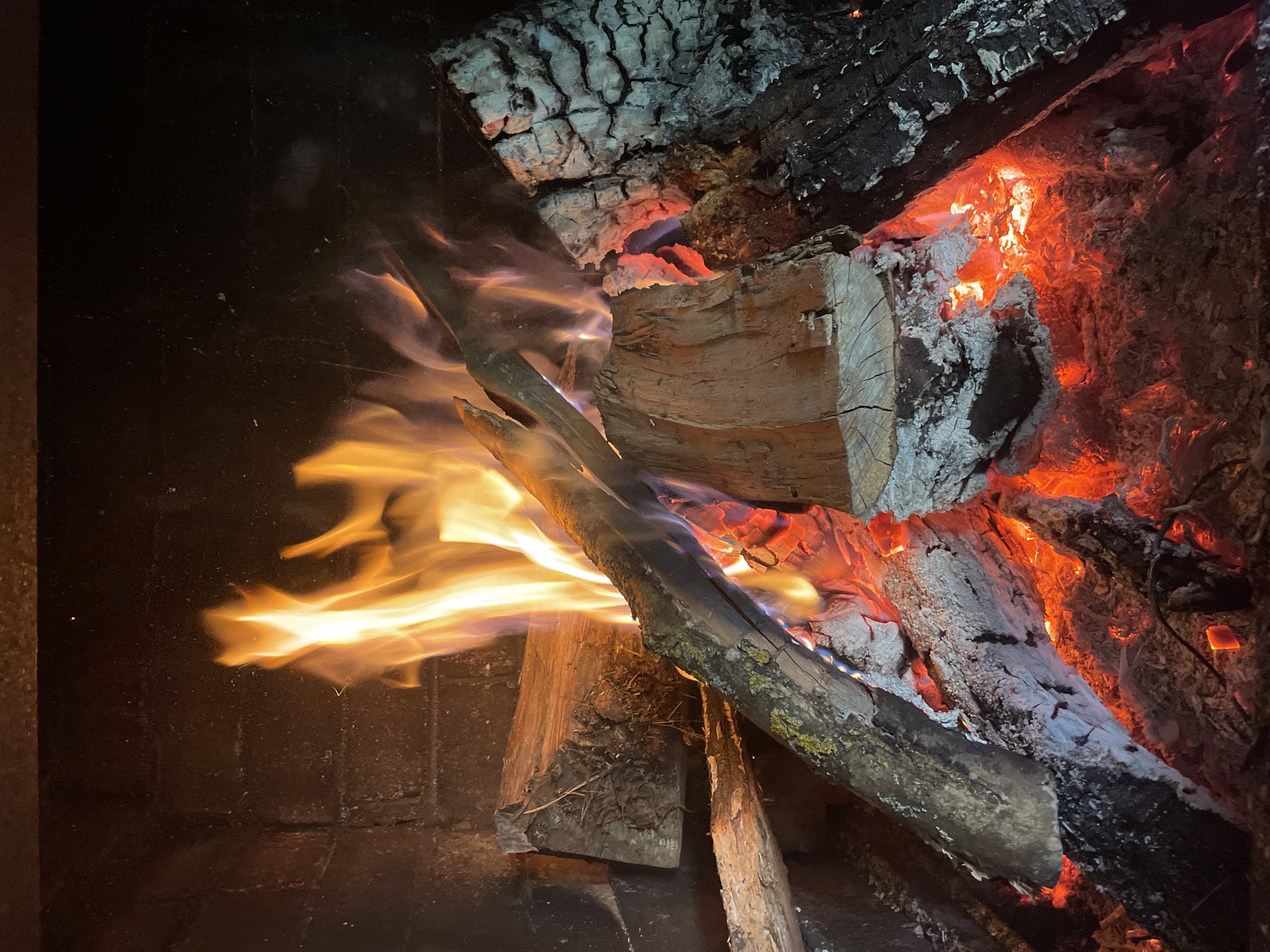 Fireplace burns with logs in Gryaznoye, Russia