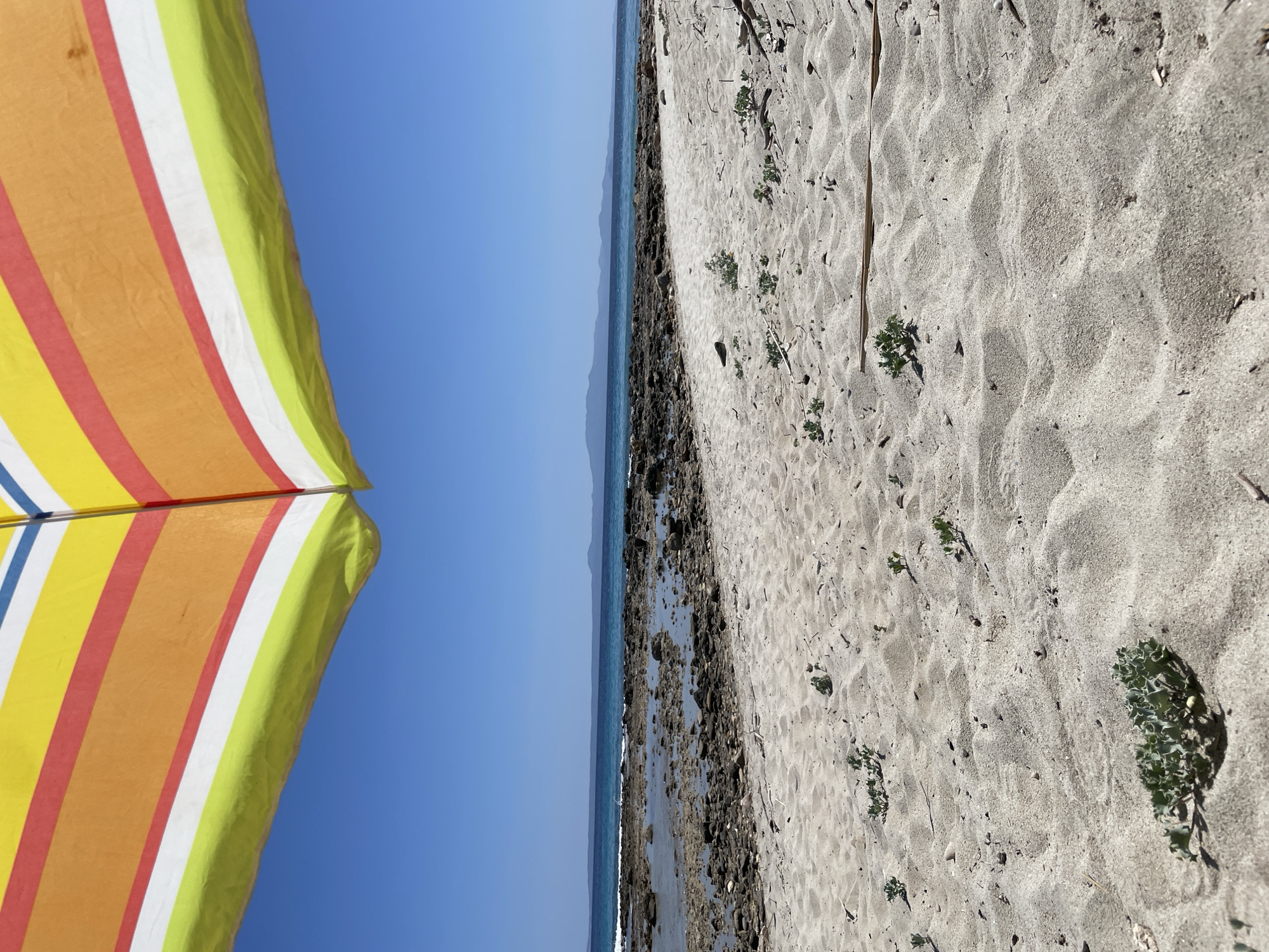 Sunny morning at a Kassandra beach with hillside views