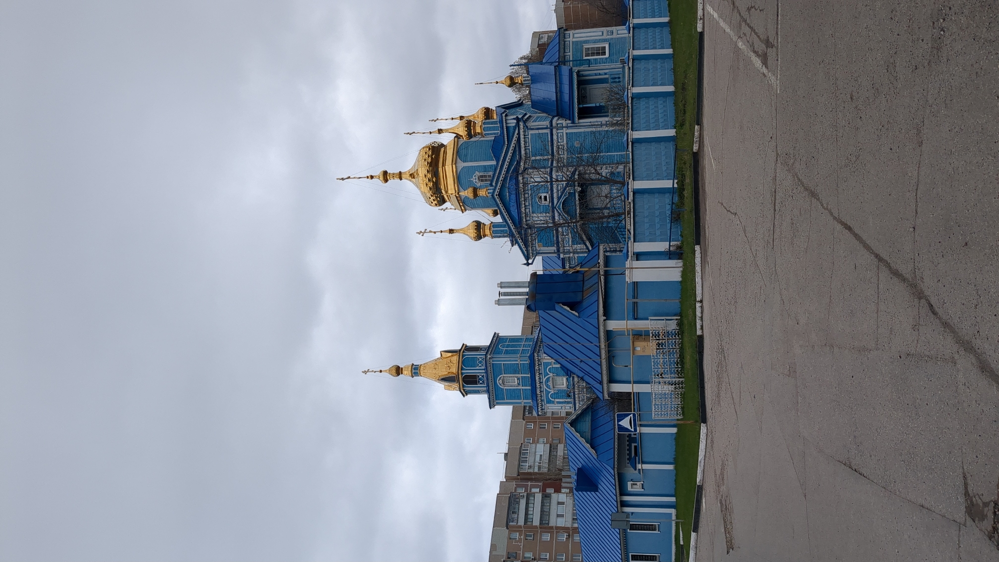 Blue wooden Orthodox church with golden domes documented in Ulyanovsk