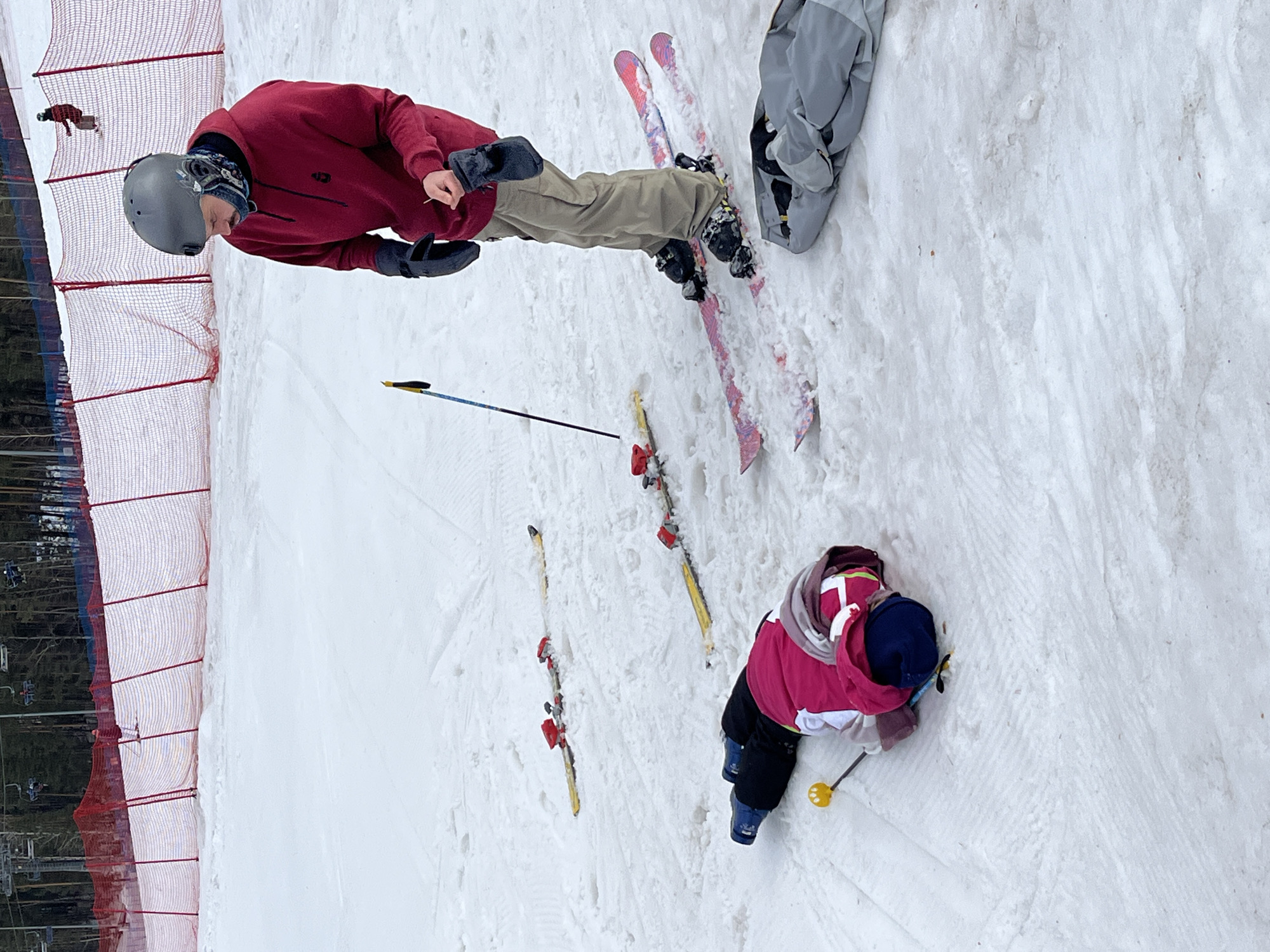 Skiers and snowboarders attempt tricks at mountain resort terrain park