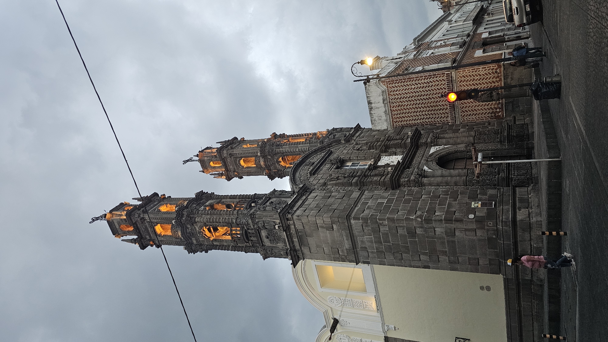 Twin-towered church photographed on Puebla street at dusk