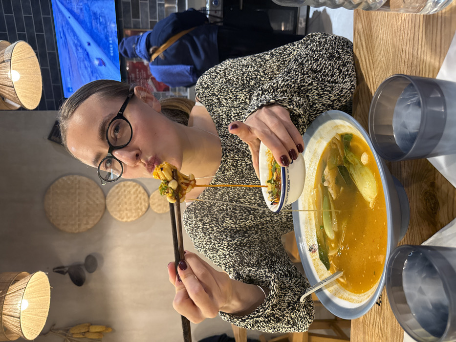 Woman dines at Paris restaurant, soup and drinks observed