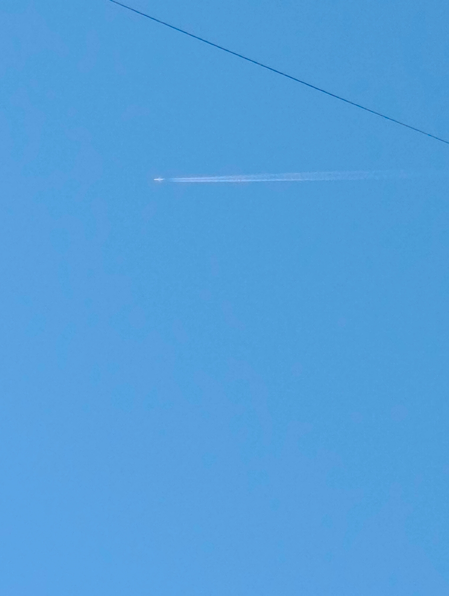 Aircraft leaves contrail over Kardzhali Bulgaria morning sky