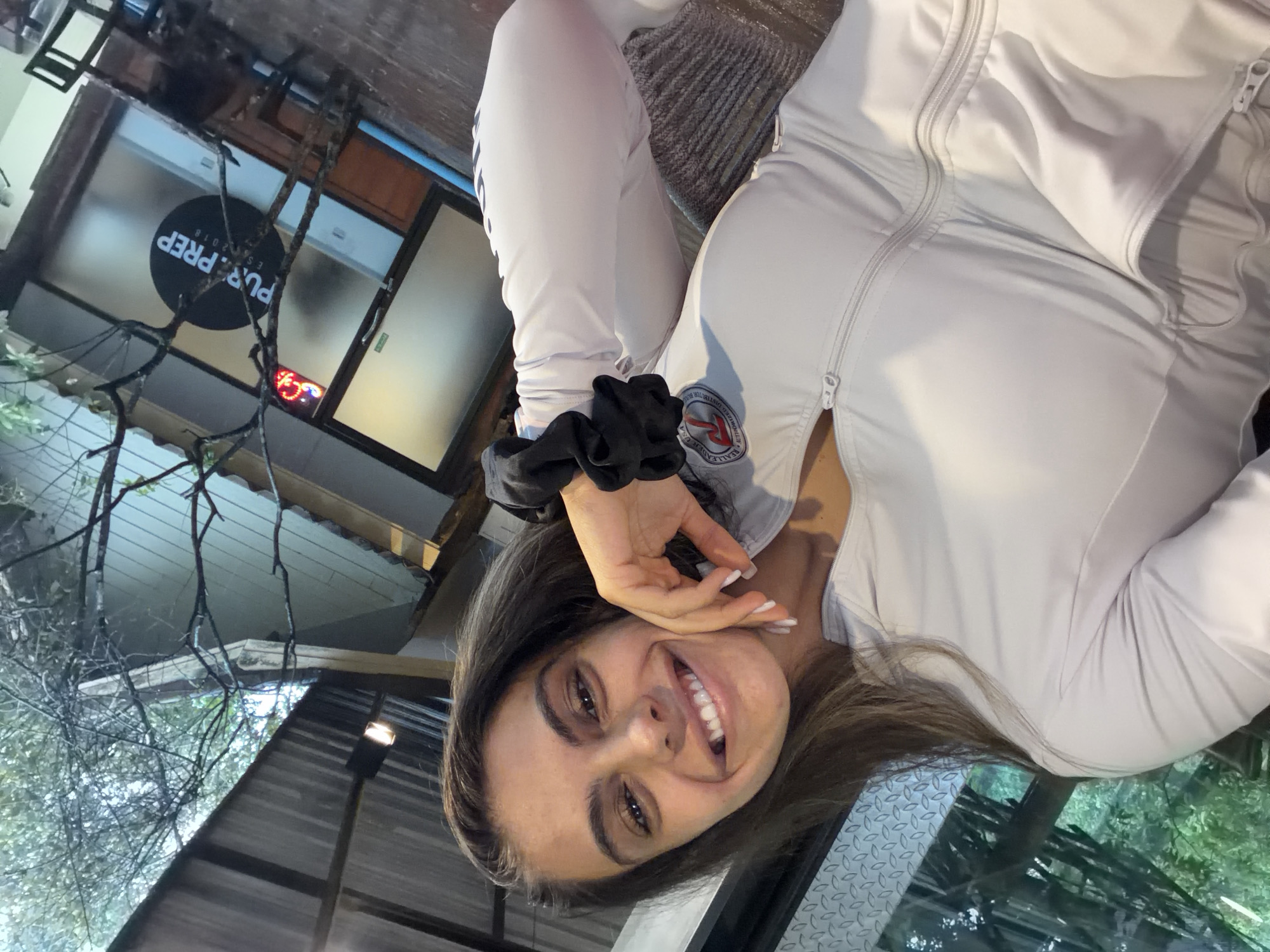 Woman takes selfie in tracksuit in Chalong, Thailand