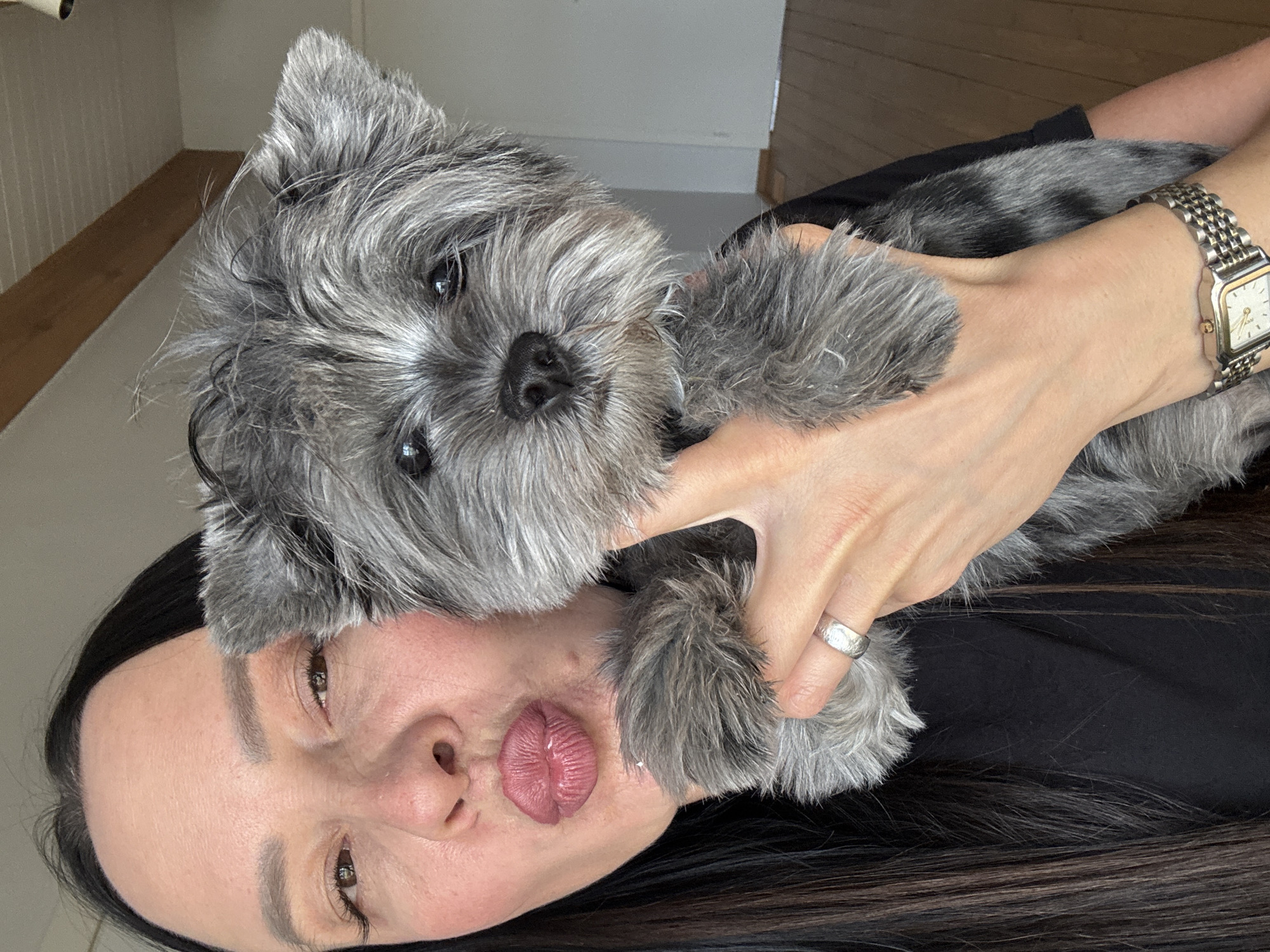 Woman photographed with small dog indoors in Chaikovsky