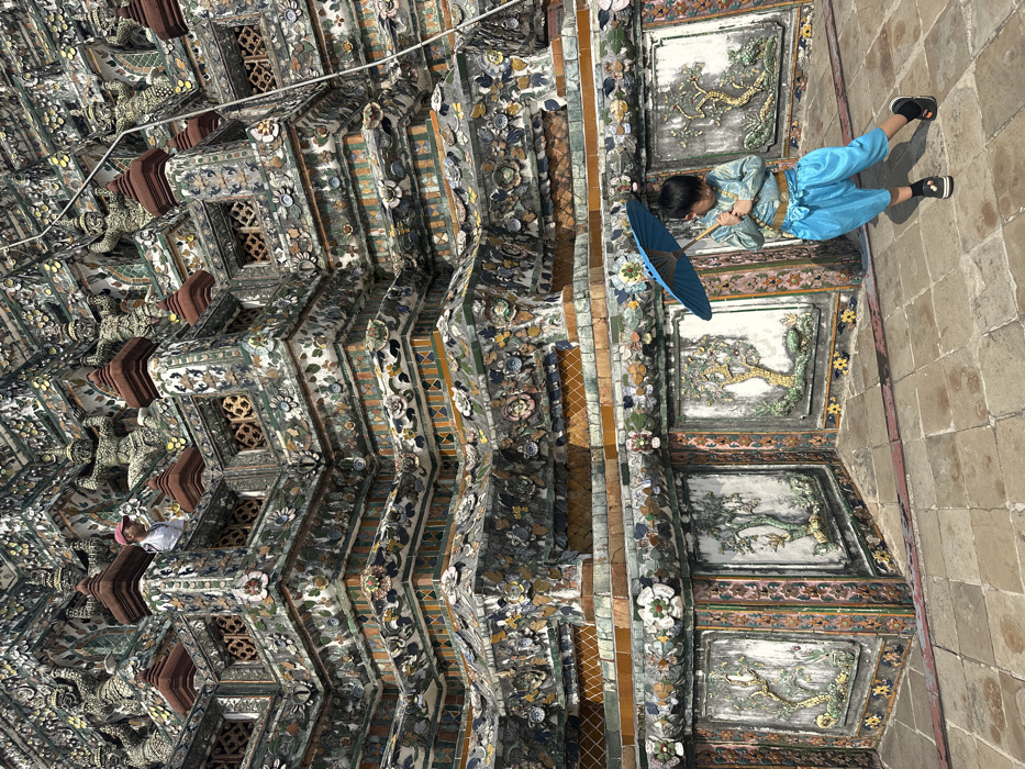 Morning visitors pose at Bangkok's Wat Arun Temple