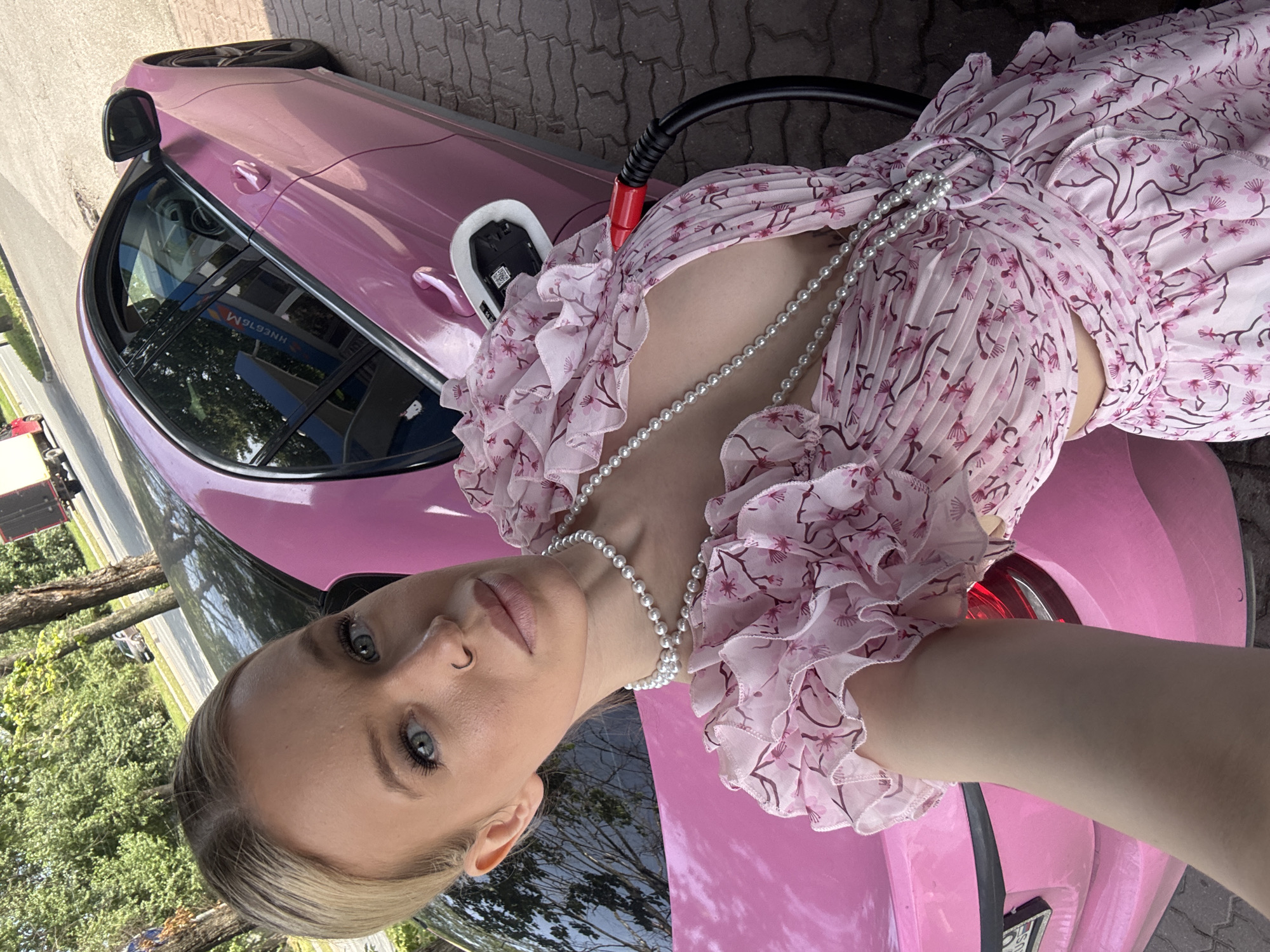 Pit stop at a Saint Petersburg EV charger, pink car in frame
