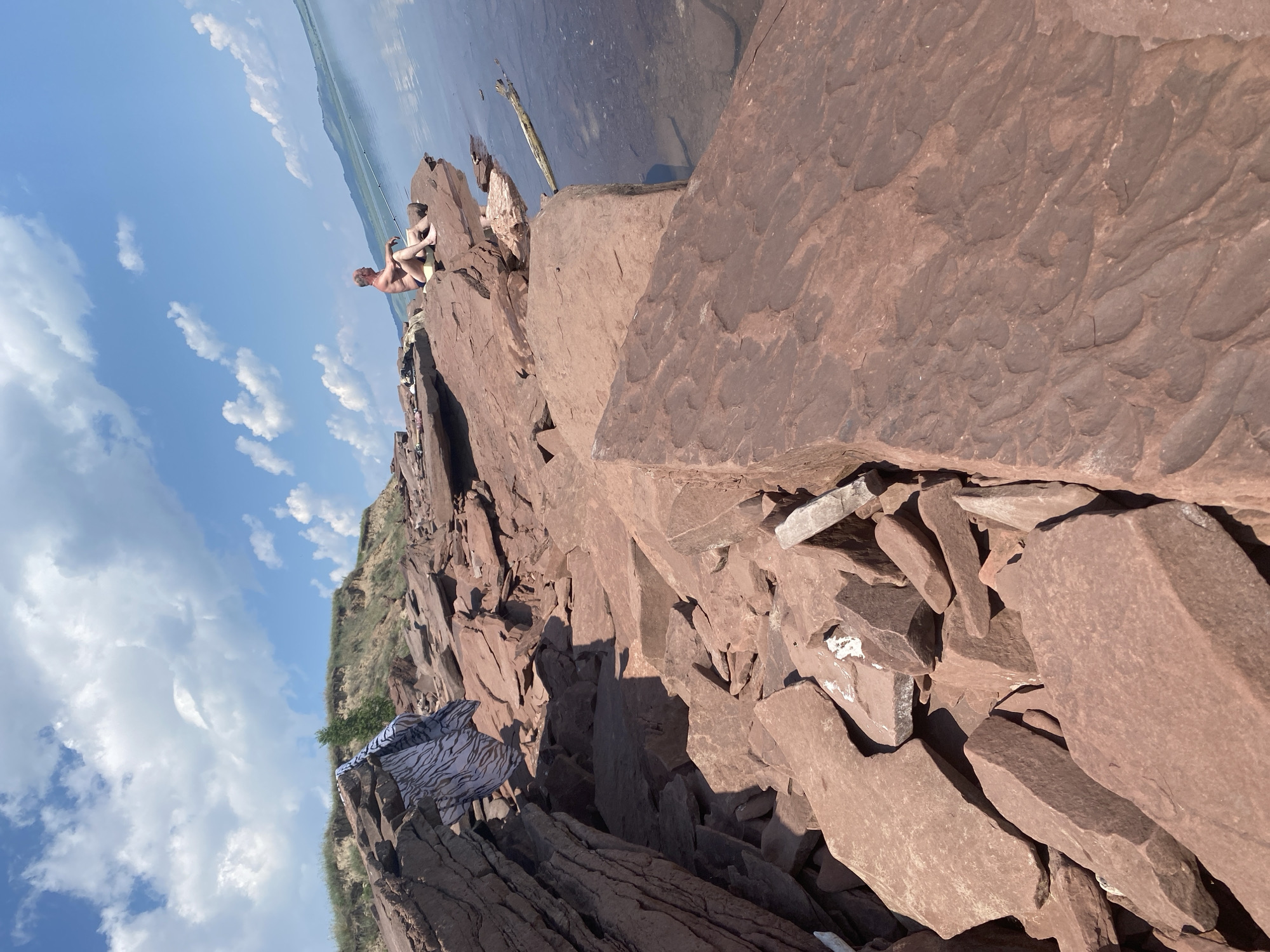 Early morning fishing session on red rocks near Ust'-Erba