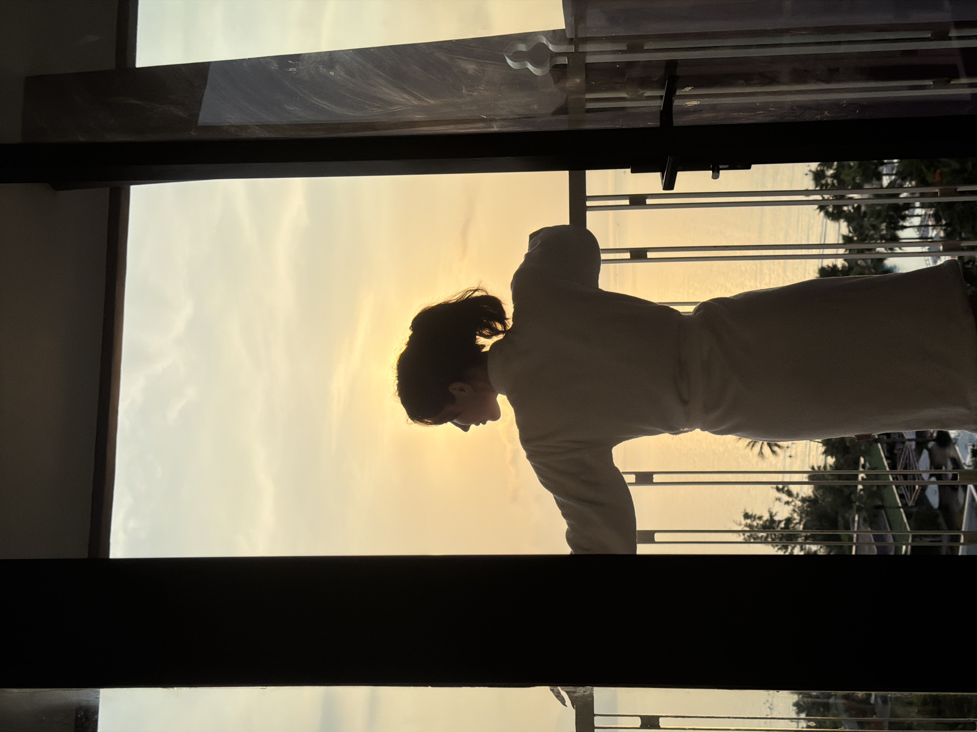 Sunset silhouette observed from high-rise balcony in Vietnam