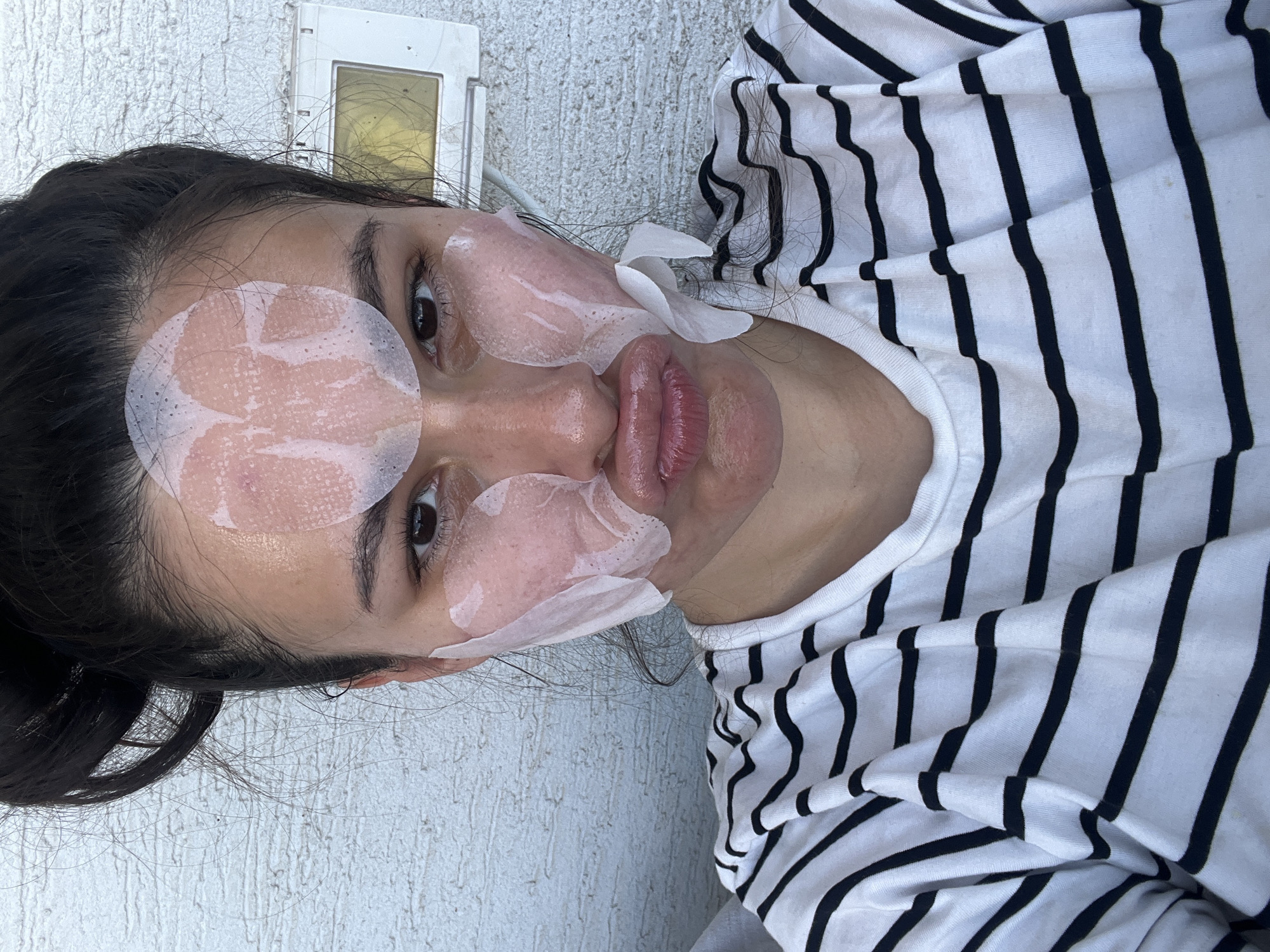 Woman uses facial patches during skincare routine in Kiryat Bialik