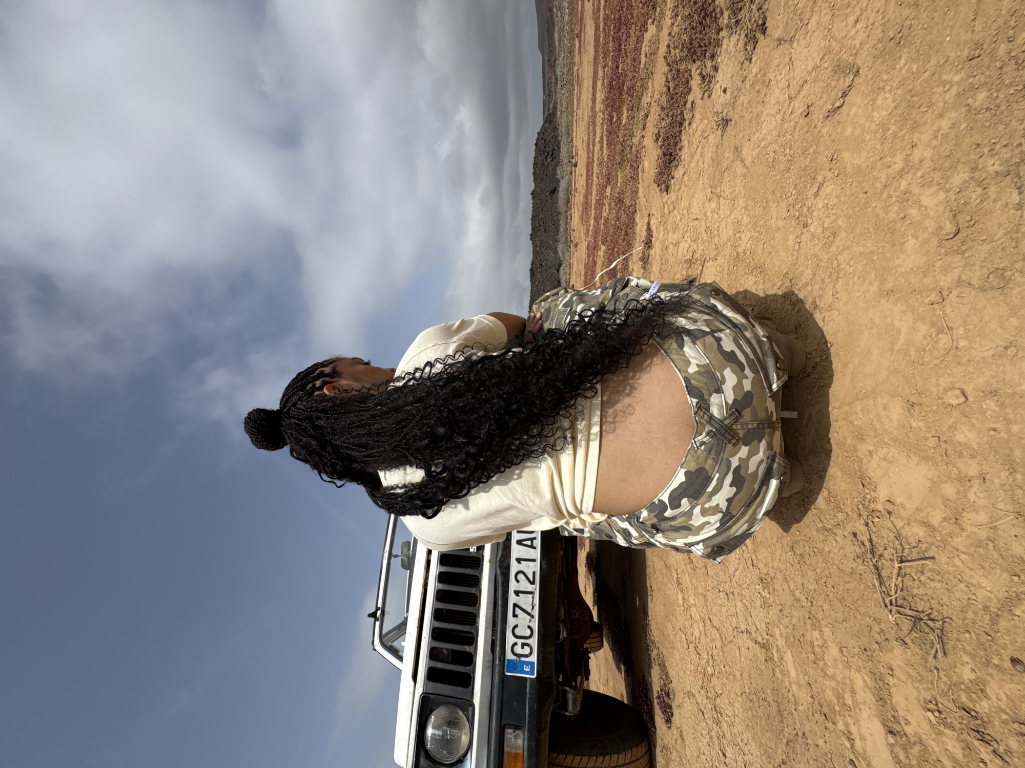 Person with braids spotted at white SUV in Tinajo desert